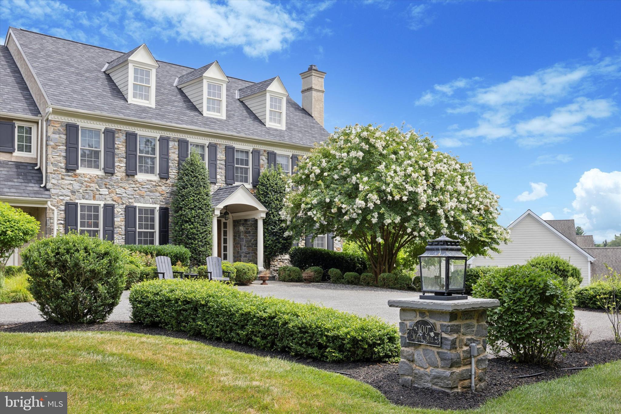 Welcome to 100 Water Mill Lane, a stunning showcase of semi-custom stone-front homes nestled in the prestigious enclave of Water Mill in Media, PA. This exclusive community offers the perfect blend of luxury, comfort, and convenience, all within the bounds of the notable Rose Tree Media school district.

As you enter this meticulously crafted home, you are greeted by an elegant foyer that sets the tone for the exquisite craftsmanship and attention to detail found throughout. The spacious floor plan seamlessly combines modern amenities with timeless design, creating an inviting atmosphere for both entertaining and everyday living.

The gourmet kitchen, complete with SubZero and Wolf appliances and wine cooler, custom cabinetry, and a center island, is a chef's dream come true. The Butler's area is complete with granite wet bar, ample cabinetry and a full Pantry closet. The adjacent living spaces, including a gracious family room with inviting gas fireplace and custom millwork cabinetry and formal dining area, provide the ideal setting for hosting gatherings and creating cherished memories with loved ones.

Upstairs, the luxurious master suite offers a serene retreat with a spa-like en-suite bath and ample closet space, 2 walk in closets and a dressing area. Additional bedrooms and well-appointed bathrooms ensure comfort and privacy for family members and guests alike.

Outside, the meticulously landscaped grounds offer a private oasis for relaxation and outdoor enjoyment. Whether it's a quiet morning coffee on the deck or a lively barbecue with friends, or formal cocktails in the front courtyard, the possibilities of the backyard and outdoor spaces are unlimited.

Conveniently located in an excellent school district, this home offers access to top-notch educational opportunities for growing families. The nearby amenities, including shopping, dining, and entertainment options, further enhance the appeal of this exceptional location. Easy access to Center City, King of Prussia, the Main Line, West Chester and the New Jersey shore points as well as accessibility to the train for commuters.

Don't miss the opportunity to experience the epitome of luxury living in this prestigious enclave. Schedule a showing today and make 100 Water Mill Ln. your new address for sophisticated suburban living.
