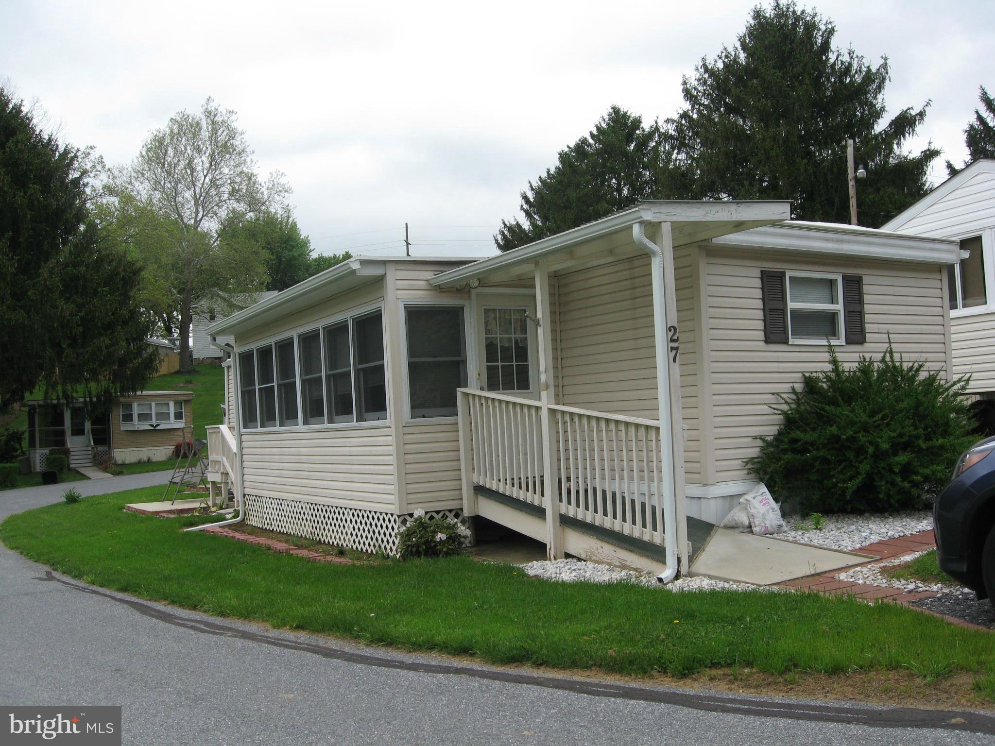 This older mobile home was renovated by a previous owner & the present owner has continued to make improvements.  One would never believe it is a 1967 mobile home.Roof replaced with a 20 yr. rubber roof. ceramic bath, kitchen island with ceramic top, hardwood floors, glass enclosed porch overlooking large pond. Park rent of $578 monthly includes water,sewer,taxes,2X week trash pickup& snow removal