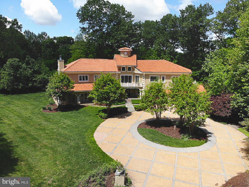 This elegant and spacious 6 bedroom, 6 full bath home in a private setting is perfect for your family and friends. This home will impress with a unique design and build for Great Falls. Entertain your guests in any one of the 3 balconies, 2 patios, 2 offices, a beautiful deck, the conference room, or the art room. The unique Spanish designed home comes with Brazilian Cherry hardwood floors and a custom floating staircase with wrought-iron railing. The stunning kitchen comes with custom wood-made cabinets, breakfast bar, a sitting area, and designer appliances. The home also has a large 3 1/2 garage, 3 gas fireplaces, new carpeting and fresh paint.