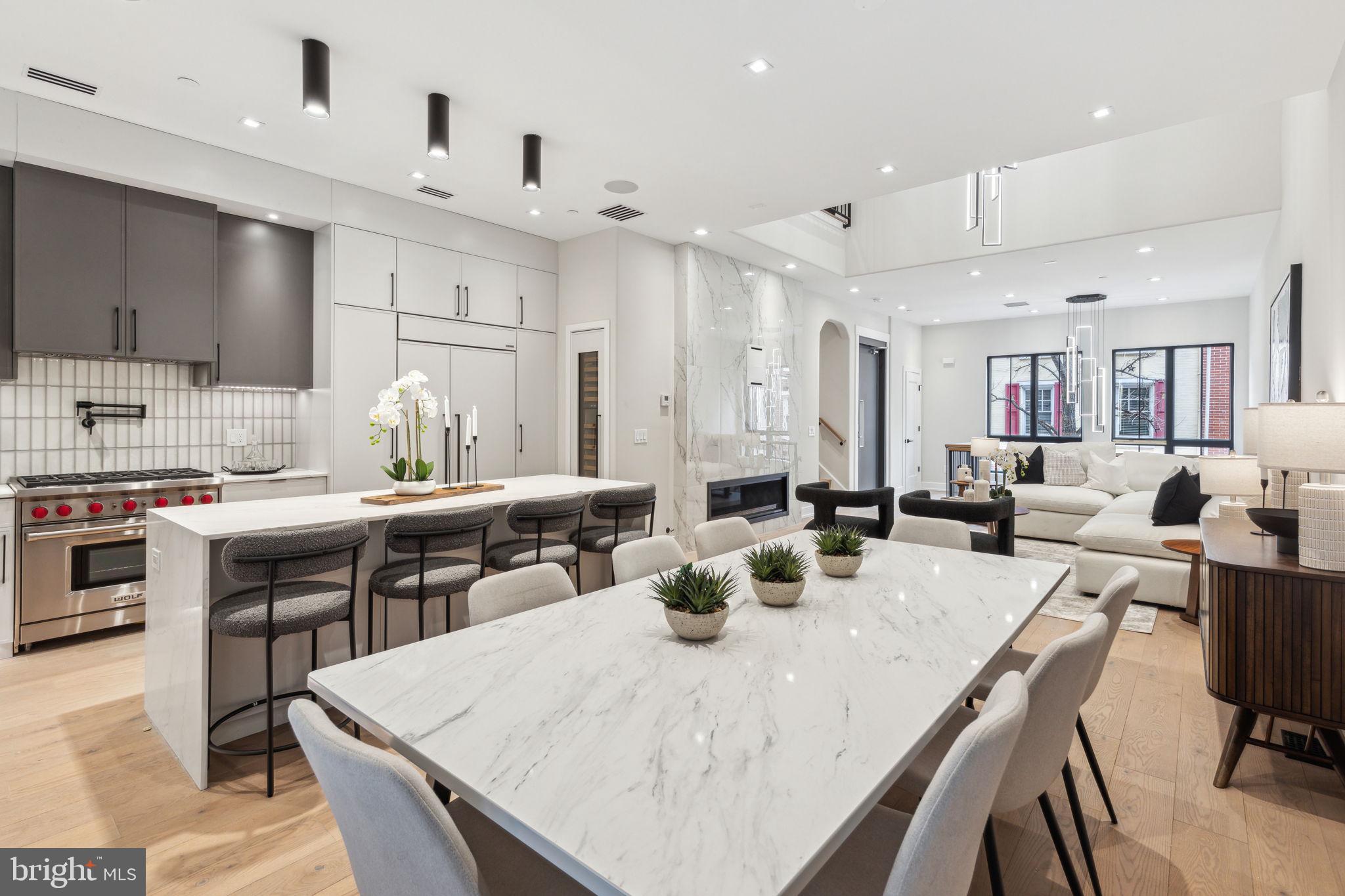 Rittenhouse Square new construction in Albert M Greenfield School Catchment, fully loaded and now available! This exquisite residence rises 46 feet high, creating impressive ceiling heights throughout, including a breathtaking two-story living area with expansive views overlooking Pine Street. Upon entering, you're welcomed by a stunning herringbone tile foyer, complete with custom millwork cabinetry perfect for storing shoes, coats, and other belongings. This level also offers access to the oversized two-car garage, which includes electric vehicle charging capabilities. The custom-designed staircase, featuring thick floating oak treads, leads to an expansive living space bathed in natural light throughout the day. The wide-plank herringbone flooring continues into the open living and dining areas, setting a tone of sophistication. The state-of-the-art chef’s kitchen is equipped with Sub-Zero and Wolf appliances, custom cabinetry designed for maximum storage, and a wet bar. The living room is perfect for entertaining or cozy nights in, with a large gas fireplace as the focal point. Adjacent to the kitchen is a generously sized patio, complete with a gas line for effortless outdoor grilling, and ideal for al fresco dining. On the third floor, you’ll find two spacious en-suite bedrooms, each with custom closets and beautifully appointed bathrooms. A full-sized laundry room with washer, dryer, and thoughtfully designed cabinetry is also located on this floor for ultimate convenience. The fourth floor is a true private retreat – an expansive primary bedroom suite with amazing views, a private balcony, a luxuriously outfitted walk-in closet, and a spa-inspired bathroom which features heated floors, a steam shower with multiple jets, and a serene ambiance, creating the perfect place to unwind. The top floor boasts an impressive roof deck designed for entertaining. This massive outdoor space is wired for TV and sound, and is even capable of accommodating a hot tub, making it the perfect place to relax while enjoying sweeping views of Rittenhouse Square as the day fades into night. Bowery Place also offers numerous additional luxury features, including a five-stop elevator, a full AV tech package, and much more. Expertly designed and brought to life by ZATOS Investments & Construction, this is truly a must-see property. Please note: Taxes are not $1. Buyers are responsible for verifying taxes and square footage independently. The homes come with a new tax abatement. The PAR Standard Agreement of Sale for New Construction of sale must be used for new construction properties whether completed or not.
