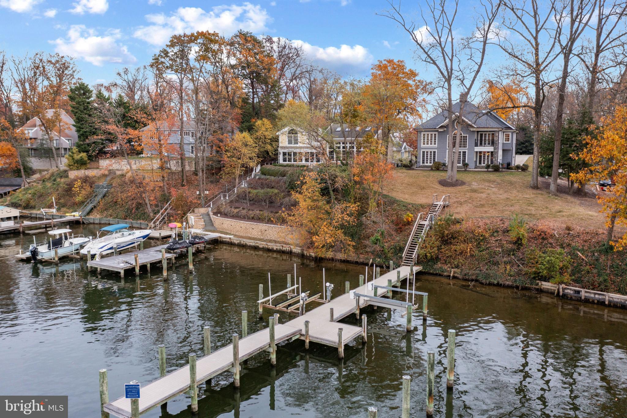 Waterfront living in sought after North Shore! This dignified waterfront home is surrounded by stunning properties all commanding expansive views of Park Creek and out to the majestic Magothy River. The western facing panoramic water views offer the perfect vista to savor the sparkling afternoon sunshine and glorious sunsets every day.  This stately home, custom built in 2009 and recently refreshed with new paint, boasts 4 bedrooms and 4 baths with an open floor plan, high ceilings and a gourmet kitchen with a large center island. Enjoy breathtaking water views that grace nearly every room, creating a serene backdrop to your daily life. The Marvin doors and windows flood the Living room with light and highlight the stunning 2 story, double sided, stone fireplace.  Perfect for cozy evening! The water side patio provides a tranquil area for dining, relaxing and outdoor entertaining. Completing the main level is an expansive dining room, impressive foyer and sitting room with full bath that would make a great guest bedroom.  Head upstairs to the spectacular Primary suite with views to the Living room below, spa-like bathroom, adjoining bonus room and private balcony with unparalleled water views.  Kick back with an evening cocktails and savor the ultimate setting for taking in breathtaking sunsets. The additional waterside bedroom with ensuite bath and spacious bedroom with adjacent hall bath provide ample room and privacy for family and guests.  The bonus 3rd floor with soaring ceilings, skylights and tons of potential has endless possibilities to suit your families needs and the fully finished lower level with bonus room, walkout stairs and fireplace is perfectly prepared to provide ample space for gatherings big and small.  Outside, the large front and back yard, 2 car garage and long driveway with plenty of parking can easily accommodate all the water loving friends that are sure to join you. The private pier with deep water, 2 boat lifts and multiple slips will impress even the most seasoned boater and offers the perfect location for quick access by boat to the Chesapeake Bay and beyond;  making a day out on the water easy and fun.  Commutes are a breeze with close proximity to Route 10, 100, 97 and the BWI airport. Welcome Home!
