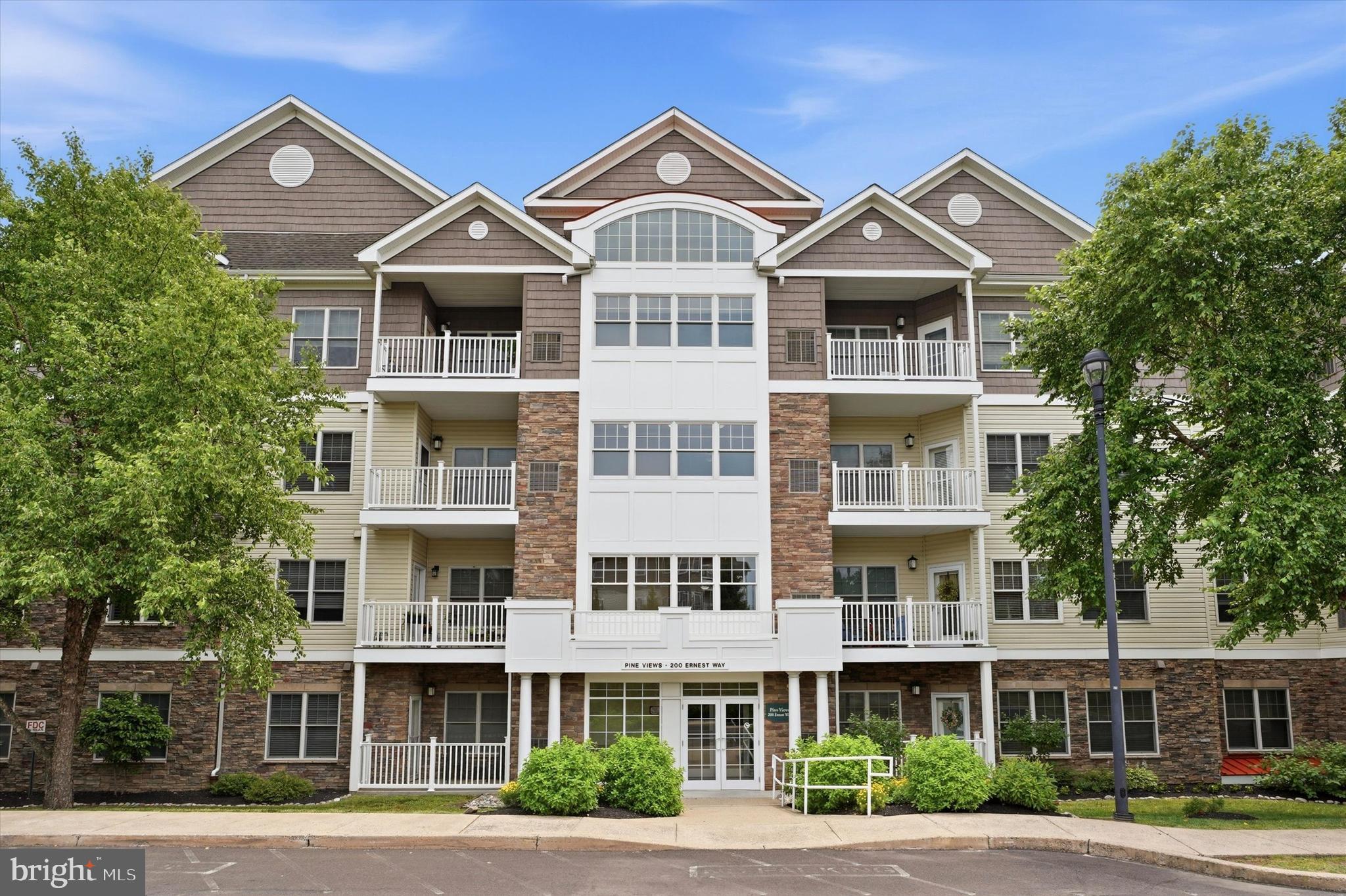 Permeated with natural light, this rarely available 3rd floor unit is yours to enjoy at the sought after 55+ "Pine Views" community where all units are owned-occupied! This amazing, immaculate one-bedroom plus den with 9 ft ceilings has a seamless living area, that can be made more private by closing some of the doors and features a gas fireplace and access to a private covered balcony. The den can be used as an additional bedroom, formal dining room, living room, or office. Gorgeous, peaceful views surround this fob-secure building! The spacious kitchen boasts stainless steel appliances, gas cooking, ample counter space and cabinets. The primary bedroom features an en-suite bathroom with a walk-in shower!  Elevator access to the parking garage where there is assigned space, indoor mail delivery, and trash disposal contribute to the easy living, active lifestyle. A beautiful indoor swimming pool, library, art room, card/crafts room and billiards room are the main features of the Club House where there is also a large kitchen for private and community events. Boarding Pennypack Park, the community is still only minutes from Routes 1, I95, and 309, and the Fox Chase Regional Rail station. It’s time to make the change, make it your own, and enjoy!