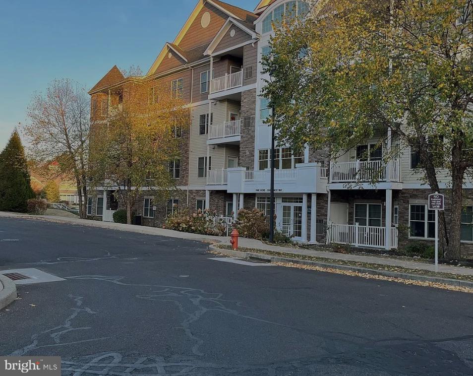 Permeated with natural light, this rarely available 3rd floor unit is yours to enjoy at the sought after 55+ "Pine Views" community where all units are owned-occupied! This amazing, immaculate one-bedroom plus den with 9 ft ceilings has a seamless living area, that can be made more private by closing some of the doors and features a gas fireplace and access to a private covered balcony. The den can be used as an additional bedroom, formal dining room, living room, or office. Gorgeous, peaceful views surround this fob-secure building! The spacious kitchen boasts stainless steel appliances, gas cooking, ample counter space and cabinets. The primary bedroom features an en-suite bathroom with a walk-in shower!  Elevator access to the parking garage where there is assigned space, indoor mail delivery, and trash disposal contribute to the easy living, active lifestyle. A beautiful indoor swimming pool, library, art room, card/crafts room and billiards room are the main features of the Club House where there is also a large kitchen for private and community events. Boarding Pennypack Park, the community is still only minutes from Routes 1, I95, and 309, and the Fox Chase Regional Rail station. It’s time to make the change, make it your own, and enjoy!