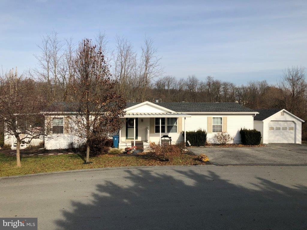 Very roomy 1,512 sq. foot double wide mobile home in a 55+ community, Crestview Acres. Home features 3 BR's, all with walk in closets, 2.5 Baths with skylights, master bath has a soaking tub, large shower, and large vanity w/double  sinks. Kitchen has lots of cabinets and a pantry area. Home has an intercom/radio, wood burning fireplace in LR and a nice side porch for entertaining. This lot backs up to open area where wildlife can be seen and the walking path for the community. This is a must see