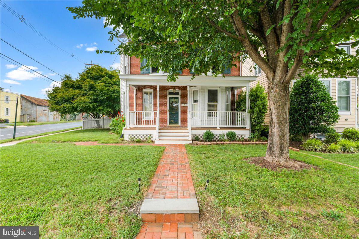 901 N Market Street is the kind of place that makes people stop and say "Wait. . .  this is downtown?"  A beautiful brick historic home (just outside the historic district) with original hardwood floors, high ceilings, gas furnace installed in 2015, new CAC in 2025, remodeled first floor bathroom in 2025, and replacement roof in 2017.  The home provides plenty of natural light and move-in ready, functional layout supported by features of the 1900's.  When stepping outside, you're surrounded by lush, intentional landscaping that feels more like a private garden than a city lot.  Mature plantings, layered greenery, and a fully fenced yard (fence 2020) creates a peaceful retreat and perfect hangout spot.  Whether its weekend cookouts, evening drinks, or just letting the dog run free, this backyard delivers a level of privacy and calm you almost never find in downtown Frederick.  And then there's the front porch for morning coffee, late-night conversations, waving and connecting with neighbors passing by.  This historic home delivers the 1900's charm and modern conveniences yet just a short walk to everything downtown Frederick has to offer and less than two blocks from the Frederick YMCA and Staley Park, in addition to walking distance to all three level schools.   This location cannot be beat!  It's rare. Its unexpected.  And it's the kind of property people remember.