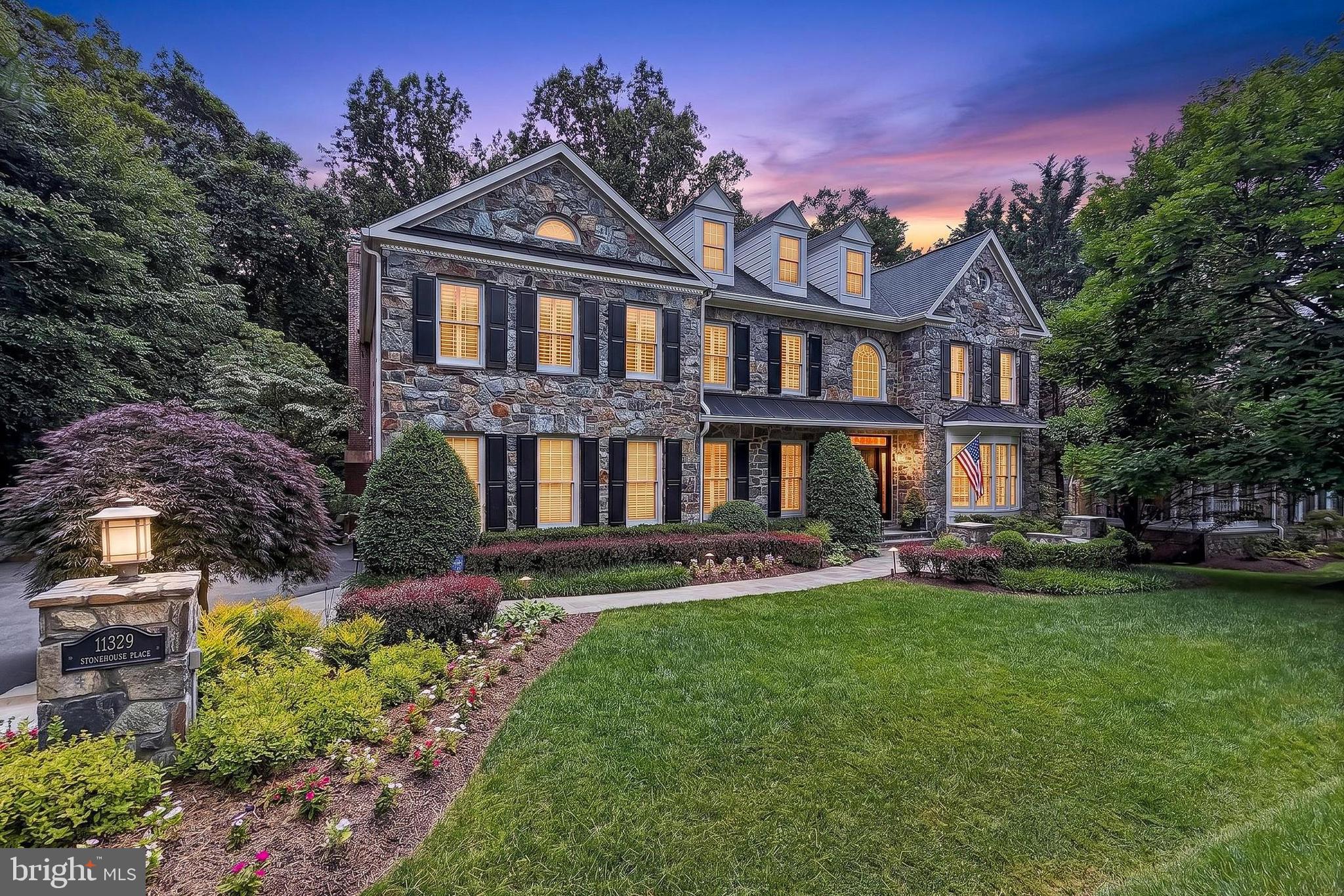 Welcome to Cascade Estates, this stunning stone front home feels like your own private sanctuary backing to deep private woods, peacefully situated in the prestigious community of Lowes Island Estates.  This elegant estate is in pristine condition, with a traditional yet open floor plan with a soaring entry foyer, private home office with built-in bookshelves, and formal living and dining rooms elegantly finished with crown molding, chair rail and wainscoting and architectural columns.  This exceptional 6 bedroom, 4.5 bath home spans over 6400 sq ft on 3 finished levels, appointed with high end finishes to include plantation shutters, hardwood floors, luxury vinyl plank flooring, recessed lighting and elegant ceiling chandeliers and updated bathrooms throughout. The gourmet kitchen is the true heart of this home, featuring soft white cabinetry, lux white marble countertops and center island with barstool seating, pendant and recessed lighting, a walk-in pantry, high end stainless steel appliances, to include a Wolf 6-burner gas range with pot filler faucet,  Wolf convection wall oven and a Microwave, Miele built-in coffee system, SUB-ZERO French door refrigerator, wine cooler and Bosch dishwasher.  The adjoining breakfast room with access to the deck, features custom built in banquet seating,  perfect for casual dining or formal entertaining.  Directly off the kitchen, a conveniently located Laundry Room with a utility sink and built-in cabinetry leads to the 2 car garage.   The gourmet kitchen opens to a  sun-drenched family room with built-in cabinetry and a mantled gas fireplace, set in a stone accent wall and a secondary back staircase to the bedroom level.  A conveniently located powder room is located off the foyer hall. 
Upstairs the impressive primary suite spans over 660 sq ft featuring vaulted ceilings, adjoining sitting room, dual walk-in closets with custom built-ins, a dressing area,  and rich hardwood flooring. The luxurious primary bath includes dual vanities, multi shower head glass enclosed shower, tile flooring and soaking tub. Three additional generously sized bedrooms all with walk-in closets complete the upper level,  the guest suite features an en-suite bath and a jack and jill bath with dual vanities adjoining the other 2 bedrooms. 
The walk-out daylight lower level is an entertainer's dream and provides plenty of space for kids, family and guest.  A large hallway flanked by built-in bookshelves leads to a large recreation room featuring a unique custom built-in child's playhouse   or special hideaway for your favorite pet, a dedicated exercise room with adjoining storage/utility room, and a secondary large storage room.  A privately located bedroom and full bath makes for the ideal accommodations for guest or au pair living, the 6th bedroom is currently being utilized as a media room with projector, screen and built-in speakers to convey. 
One of the very special highlights of this home is the magnificent outdoor entertaining areas, with an expansive deck off the main floor living areas, with a lovely screened-in gazebo porch overlooking breathtaking views of mature trees, ornamental plantings and professionally manicured lawn, easily accessed from both the main and lower level of the home.  Features: Updates include a new roof in 2024, Gas fireplace 2024, 2026 bedroom carpeting, Furnace 2022, Hvac UV filtration system 2024,  Water heater aprx 2018, House Generator, Whole house water filtration system, Lawn Irrigation system, Landscape lighting.  
Lowes Island is part of the amenity-rich Cascades community featuring 5 pools, 25 tennis/pickleball courts, fitness centers, 25+ playgrounds, bocce, soccer fields, and miles of scenic trails. Steps to Algonkian Regional Park with Potomac River access, boating, and canoe launches. Minutes to Trump National Golf Club, shopping, dining, and major commuter routes to D.C. to include the Dulles Toll Road, I-495 and the expanding metro system.  A very special home!
