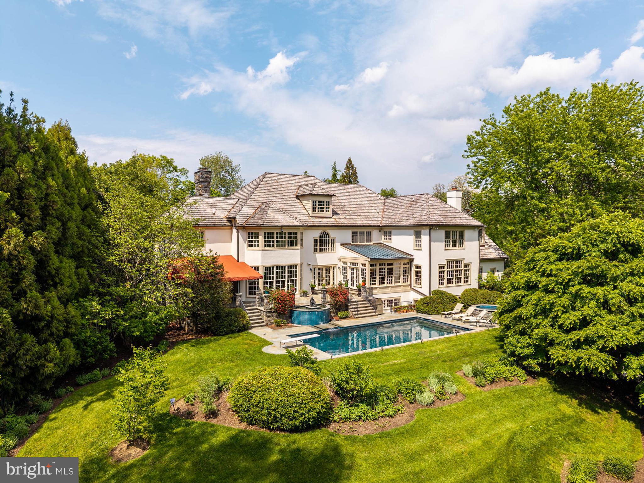 REAL ESTATE TAXES CUT $19,500 PER YEAR — FROM  $75,000 TO  $55,500. The Montgomery County Board of Assessment Appeals has reduced this property’s assessment by 26%, effective with the 2027 tax year (January 2027 for county and township taxes; July 2027 for school taxes). That is $19,500 back in the owner’s pocket annually, whether purchasing with cash or financing. If taxes were the reason this property didn’t work before, the math has changed.

At the end of a cul-de-sac in Villanova, on 1.26 level, manicured acres, this Pohlig-built stone manor home demonstrates the construction discipline and architectural consistency that define the builder’s work.

A front-to-rear center hall organizes the first floor, with the staircase set centrally and light drawn from both ends of the house. The principal rooms open in sequence, front to back, in classical proportion.

The kitchen anchors on a granite-topped center island and opens into a breakfast room set beneath a barrel-vaulted ceiling, with two walls of windows and French doors to the flagstone terrace.

The family room is generously scaled - coffered ceiling, fireplace, a full wall of custom cabinetry, and a run of windows along the rear elevation. The living room, with a classical mantel and its own fireplace, extends to the rear of the house and shares its light.

The dining room is grandly proportioned, its tall windows reinforcing the room’s scale. A first-floor study, finished in wood with built-ins and windows on multiple exposures, sits apart from the main living rooms.

Upstairs, the primary suite includes a fireplace, a sitting area, windows on multiple exposures, walk-in closets, and a private bath. The additional bedrooms are well-proportioned. A room with an arched window serves as a second study, library, or playroom. A second-floor laundry sits within the bedroom wing.

The daylit lower level is finished for how a family lives - children and their friends, family evenings, exercise, retreat, and entertaining at scale. A dedicated home theater with tiered seating and projection. A wet bar with curved counter seating, served by a wine cellar. A pool table in the games area. Exercise room, full bath, and sauna. Open areas for play, games, and gathering.

The rear grounds are private, finished for use as much as view. A flagstone terrace opens off the breakfast room onto perennial gardens, layered plantings, a swimming pool, and a hot tub set within the same plan. Through the warm months, the principal rooms extend outside — mornings on the terrace, afternoons at the pool, al fresco dining in the evening. Southern exposure and shelter from the wind keep the terrace useful except in the coldest months.

Three-car garage. Public utilities. Lower Merion School District. A Pohlig-built stone manor home - proportioned, constructed, and detailed to the standard the name implies — set at the quiet end of a Villanova cul-de-sac that earns the architecture.​​​​​​​​​​​​​​​​