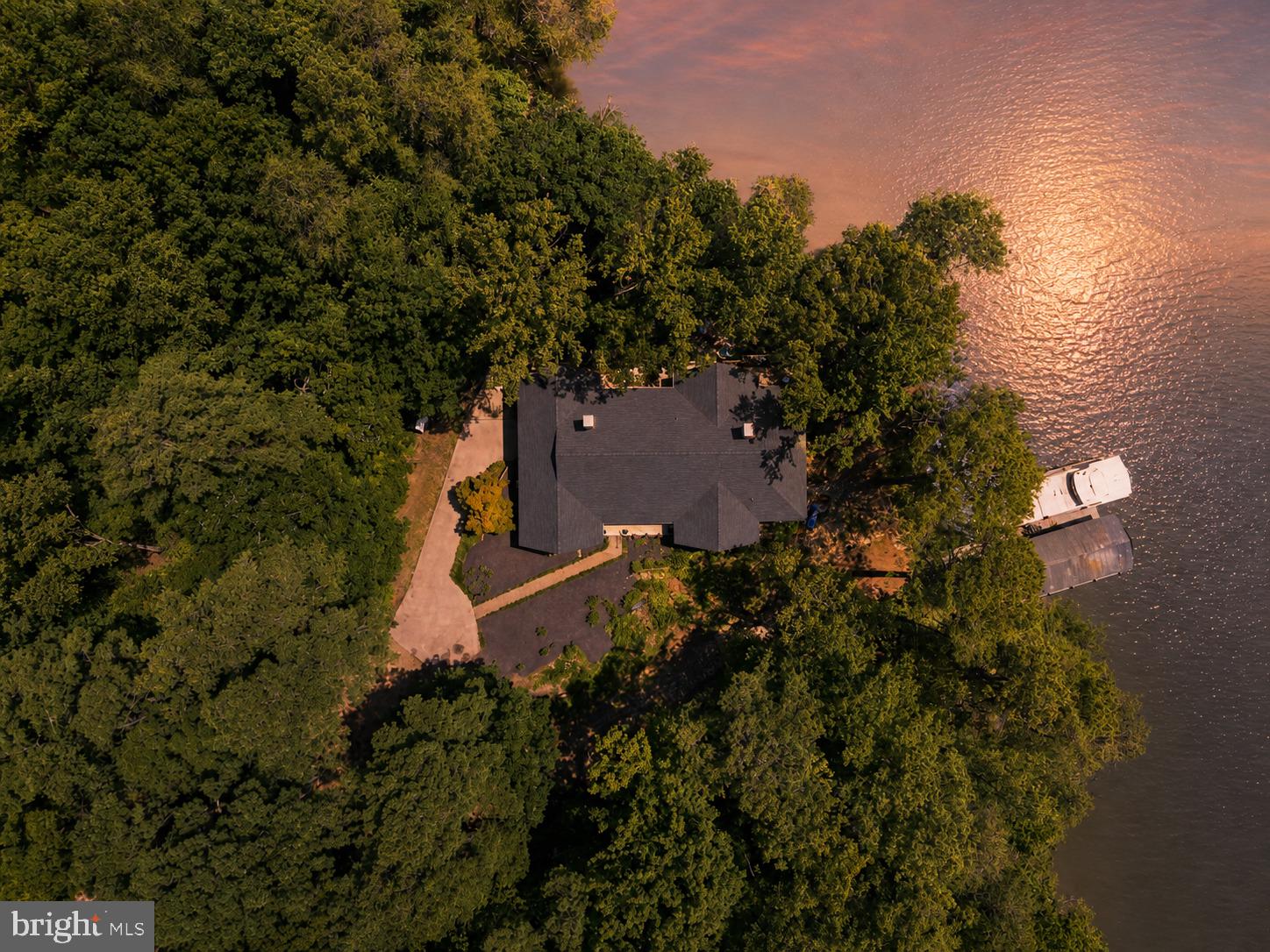 Welcome to this updated waterfront getaway on private 3+ acre lot with boathouse!  Just in time for the market, a new roof was added! High speed internet! A lovely feature is the 600’ tree lined  laneway! You will see lots of flowering trees that are stunning and they definitely add to this properties charm! 

There is a huge foyer with beautiful blue ceramic tile, which opens directly into large dining room with built in lighted china cabinets and view of water. 

Main level guest room with attached bathroom and huge walk-in closet.

Large home office/billiard room with huge windows with water view, vaulted wood paneled ceilings, fireplace and exterior door to back deck.

Large kitchen with all recently installed new stainless steel appliances, double oven, under counter ice machine and sub zero fridge. New quartz counters and subway backsplash. New main sink with touch-less faucet. New bar sink as well. Kitchen opens into large family room with breakfast nook with huge windows looking out to water. 

Family room has wood paneled vaulted ceiling, wood burning fireplace, lots of built-ins, bright and inviting. Two doors open out to 100’ deck overlooking water. 

Primary suite is huge with two sliding doors opening to deck, and tons of natural light. There’s a large dressing area/craft room and huge primary closet. An all new “hers” bath with quartz countertop with makeup area, free standing soaking tub, and separate shower. “His” bath features a shower, large vanity with built in laundry hamper and looks out to boat house and dock. 

Laundry room has exterior entry door for sandy feet and oyster hauls, so you don’t need to enter into grand foyer. Washer, dryer, utility sink, three closets for storage. 

Lower level features a huge single car garage with nice workshop space, lots of storage area and a partially built kitchen with stove and older fridge in it. Plumbed for sink. Lots of potential. The heat pump for this end of house and water heater, are in closet in garage. 

Large room with windows looking out to water, used now as guest room, but has no closet. 

Large lower level family room with two sliding doors that open to large covered porch. Wood burning fireplace, wet bar with new wine fridge. Room for extra guests and games. 

Large guest room with two sliding doors opening to covered porch. 
Guest bathroom with two sinks, and tub shower combo. 
Office/bedroom that opens to side porch leading down to dock and boat house. 

Huge utility room with two recently installed heat pumps and 2nd water heater. Plus a wall of storage shelves.
This waterfront home has all of the space and privacy you have been looking for! Merry Point Ferry and Yankee Point Marina are both close by! This property offers the perfect to blend of rural privacy and effortless coastal living. Located just minutes from historic Kilmarnock and Irvington, you’ll enjoy easy access to premier Marinas, boat launches on the Rappahannock River, boutique, shopping, and local dining. Outdoor enthusiast will love the proximity to Belle Isle State Park for hiking, kayaking, and trail exploring.  Whether you’re seeking a serene full-time residence or a peaceful weekend retreat away from the city, this Lancaster location delivers the ultimate Chesapeake Bay lifestyle!  You can drive right down to your dock! 

 Just around 1 1/2 hours from Richmond and less than 2 1/2 hours from Northern Virginia/DC. Enjoy country living surrounded by nature, with public boat ramps, and local waterways right down the road! This home is only 20 minutes to downtown Kilmarnock for shopping, dining, medical appt.  If you enjoy golfing and want to visit his historic Irvington, you are just 25 minutes away. Commuting to Richmond, Fredericksburg, and Northern Virginia is super easy! If you are coming from the DC Metro or Richmond area, you will love trading the traffic and stress for space, nature, and water without sacrificing convenience!