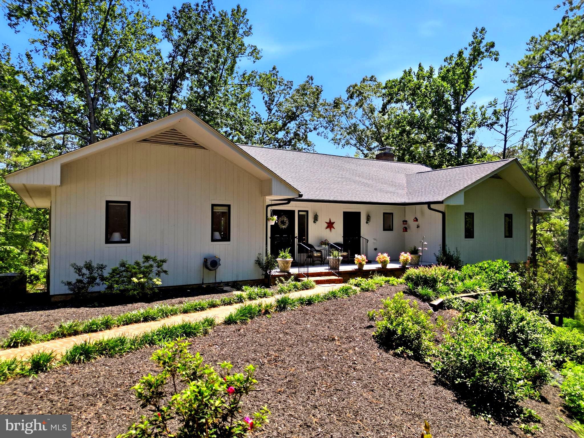 Welcome to this updated waterfront getaway on private 3+ acre lot with boathouse!  Just in time for the market, a new roof was added! High speed internet! A lovely feature is the 600’ tree lined  laneway! You will see lots of flowering trees that are stunning and they definitely add to this properties charm! 

There is a huge foyer with beautiful blue ceramic tile, which opens directly into large dining room with built in lighted china cabinets and view of water. 

Main level guest room with attached bathroom and huge walk-in closet.

Large home office/billiard room with huge windows with water view, vaulted wood paneled ceilings, fireplace and exterior door to back deck.

Large kitchen with all recently installed new stainless steel appliances, double oven, under counter ice machine and sub zero fridge. New quartz counters and subway backsplash. New main sink with touch-less faucet. New bar sink as well. Kitchen opens into large family room with breakfast nook with huge windows looking out to water. 

Family room has wood paneled vaulted ceiling, wood burning fireplace, lots of built-ins, bright and inviting. Two doors open out to 100’ deck overlooking water. 

Primary suite is huge with two sliding doors opening to deck, and tons of natural light. There’s a large dressing area/craft room and huge primary closet. An all new “hers” bath with quartz countertop with makeup area, free standing soaking tub, and separate shower. “His” bath features a shower, large vanity with built in laundry hamper and looks out to boat house and dock. 

Laundry room has exterior entry door for sandy feet and oyster hauls, so you don’t need to enter into grand foyer. Washer, dryer, utility sink, three closets for storage. 

Lower level features a huge single car garage with nice workshop space, lots of storage area and a partially built kitchen with stove and older fridge in it. Plumbed for sink. Lots of potential. The heat pump for this end of house and water heater, are in closet in garage. 

Large room with windows looking out to water, used now as guest room, but has no closet. 

Large lower level family room with two sliding doors that open to large covered porch. Wood burning fireplace, wet bar with new wine fridge. Room for extra guests and games. 

Large guest room with two sliding doors opening to covered porch. 
Guest bathroom with two sinks, and tub shower combo. 
Office/bedroom that opens to side porch leading down to dock and boat house. 

Huge utility room with two recently installed heat pumps and 2nd water heater. Plus a wall of storage shelves.
This waterfront home has all of the space and privacy you have been looking for! Merry Point Ferry and Yankee Point Marina are both close by! This property offers the perfect to blend of rural privacy and effortless coastal living. Located just minutes from historic Kilmarnock and Irvington, you’ll enjoy easy access to premier Marinas, boat launches on the Rappahannock River, boutique, shopping, and local dining. Outdoor enthusiast will love the proximity to Belle Isle State Park for hiking, kayaking, and trail exploring.  Whether you’re seeking a serene full-time residence or a peaceful weekend retreat away from the city, this Lancaster location delivers the ultimate Chesapeake Bay lifestyle!  You can drive right down to your dock! 

 Just around 1 1/2 hours from Richmond and less than 2 1/2 hours from Northern Virginia/DC. Enjoy country living surrounded by nature, with public boat ramps, and local waterways right down the road! This home is only 20 minutes to downtown Kilmarnock for shopping, dining, medical appt.  If you enjoy golfing and want to visit his historic Irvington, you are just 25 minutes away. Commuting to Richmond, Fredericksburg, and Northern Virginia is super easy! If you are coming from the DC Metro or Richmond area, you will love trading the traffic and stress for space, nature, and water without sacrificing convenience!