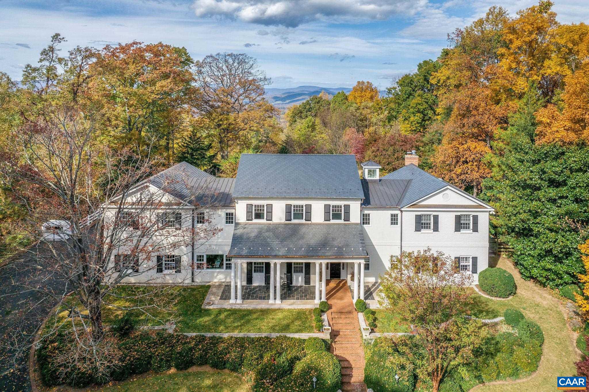 This all brick, stucco, slate and copper, c.1961 residence rests on 1 of the most dramatic, serene, protected sites in close-in, Western Albemarle County. A 14 acre property located just 10 mins to town, in the heart of Ivy w/ truly incredible views.  Panoramic views of the Bl Ridge, Ragged Mtns, Charlottesville & farmland on the way to the Bl Ridge.  These vistas embrace the 5-6 bed, 5 full, 1 half bath home & guest cottage.  Current owners recently completed a comprehensive renovation & expansion. No expenses spared, see details of the renovation in the documents tab.  The approach to this remarkable home is via a paved, gradual ascent. The expansive, dead-level rear lawn could accommodate a pool plus a level, large lawn for kicking a ball. 3 fireplaces incl' outdoors at huge bluestone terrace, 11' ceilings in entertaining rooms. Lovely, private guest cottage/office/studio enjoys views too- central HVAC, conditioned workshop in bsmnt. HUGE estate opportunity in the heart of Ivy.  Firefly fiber confirmed to be installed Spring '25.,Painted Cabinets,Exterior Fireplace,Fireplace in Kitchen,Fireplace in Study/Library