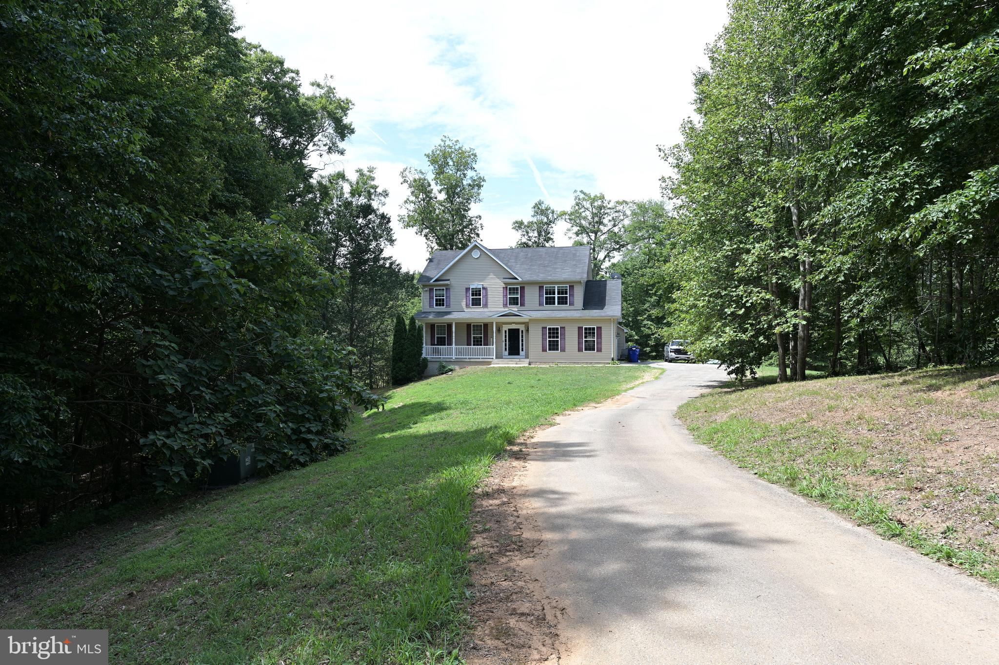 Quality built by Southernwood Homes, this 4-bedroom, 2.5-bathroom custom colonial sits on a peaceful 1.47-acre lot backing to trees, offering a private escape with beautiful seasonal views of the Wicomico River. The main level features a traditional, wide-open floor plan with a spacious foyer, elegant wide plank flooring, crown moldings, a large formal dining room, and a warm family room with a gas fireplace. At the heart of the home is a spacious country kitchen equipped with an abundance of custom wood cabinetry and a center island and breakfast area. A powder room rounds out the main level. Upstairs you’ll find 4 generously sized bedrooms, each with lighted ceiling fans and two full baths. The primary suite boasts a walk-in closet and ensuite bath with a dual sink vanity, water closet, soaking tub and separate shower. Located in the Charles County portion of Charlotte Hall, this property is just 15 minutes from the heart of La Plata, making it a highly convenient commute for Patuxent River Naval Air Station or NSF Dahlgren employees. This single-family detached property is a true sweat-equity special, providing a wonderful opportunity to customize and build instant value. The interior is primed for a fresh update with your choice of new paint and flooring, and the rear deck offers an ideal project space to restore and design your dream outdoor oasis. For even more space, the massive 1,005-square-foot unfinished walk-out basement includes high daylight windows, an outside entrance, and rough-in plumbing, giving you a completely blank canvas to finish exactly to your taste. Complete with a built-in 2-car garage and central A/C, this property combines solid quality construction with endless personalization potential!