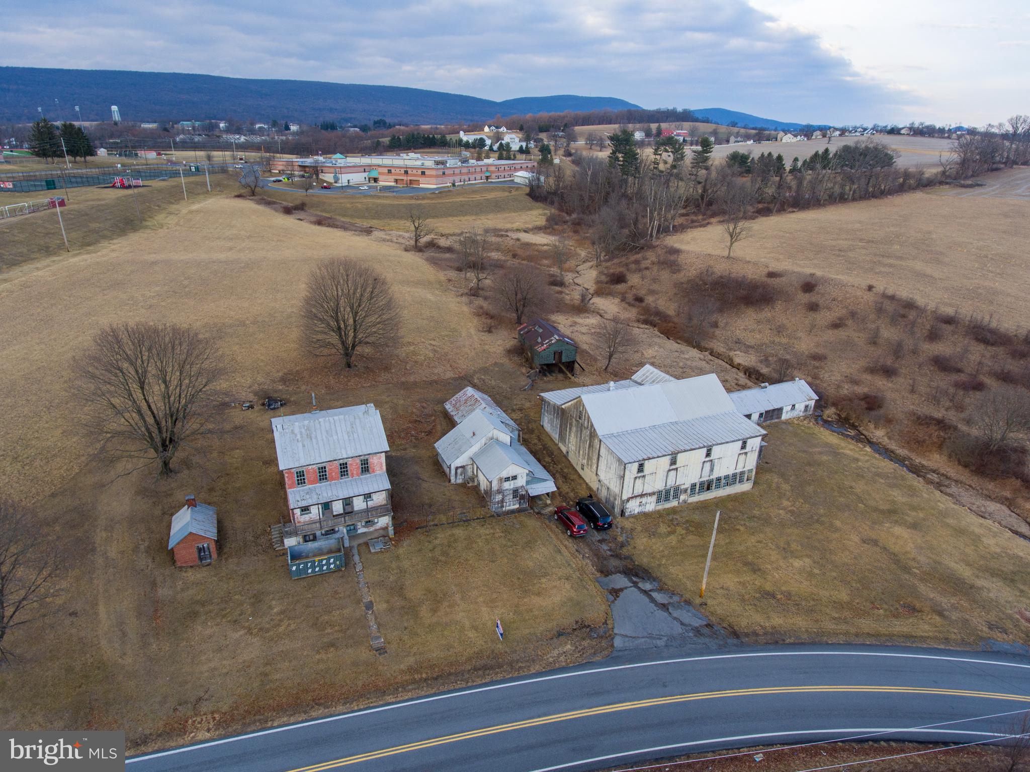 This property is being offered for sale at auction on Thursday, April 17, 2025 at 3:00 PM. List price is the suggested opening bid only and is not indicative of the final sale price. Open House: Saturday, March 29, April 5 & 12 (1-3 pm.) or by appt. Terms: 10% down day of sale; settlement within 45 days of sale.

REAL ESTATE:  32.88 ACRE FARM w/3 sty. brick farmhouse containing approx. 2,400 SF of living area. Ground level includes an eat in kitchen/living room and utility room. Main level has a foyer, 3 bedrooms and a full bath. Third level includes another kitchen, 4 bedrooms, and a full bath. The home has a full attic, 9’ ceilings, a covered front porch, coal fired hot air furnace and on site well and septic. OUTBUILDINGS: 62 x 60 stone & frame bank barn w/addition & attached 21 x 80 chicken house; 23 x 30 two-story former milkhouse w/water & electric & attached 34 x 20 garage; 10 x 15 brick smokehouse. LAND: Approximately 24 acres of tillable land with approx. 1935’ road frontage.

28.07 ACRES OPEN LAND in Windsor Township and Hamburg Boro with approx. 20 acres tillable ground and 1,300’ road frontage, zoned Ag and Medium Density Residential, with subdivision possibilities. Sold separately from farm.

NOTE:  This quiet and peaceful farm has been in the Merkel family since the mid 1800’s and this is the first opportunity for purchase. The farm offers plenty of opportunity, zoned agricultural, bordering Hamburg Boro and within minutes of downtown Hamburg with easy access to Rts. 61, 78 and Old Rt. 22. This farm and land is in Clean and Green but not in Ag Preservation. The buildings are in need of repair, offering opportunity for renovations.