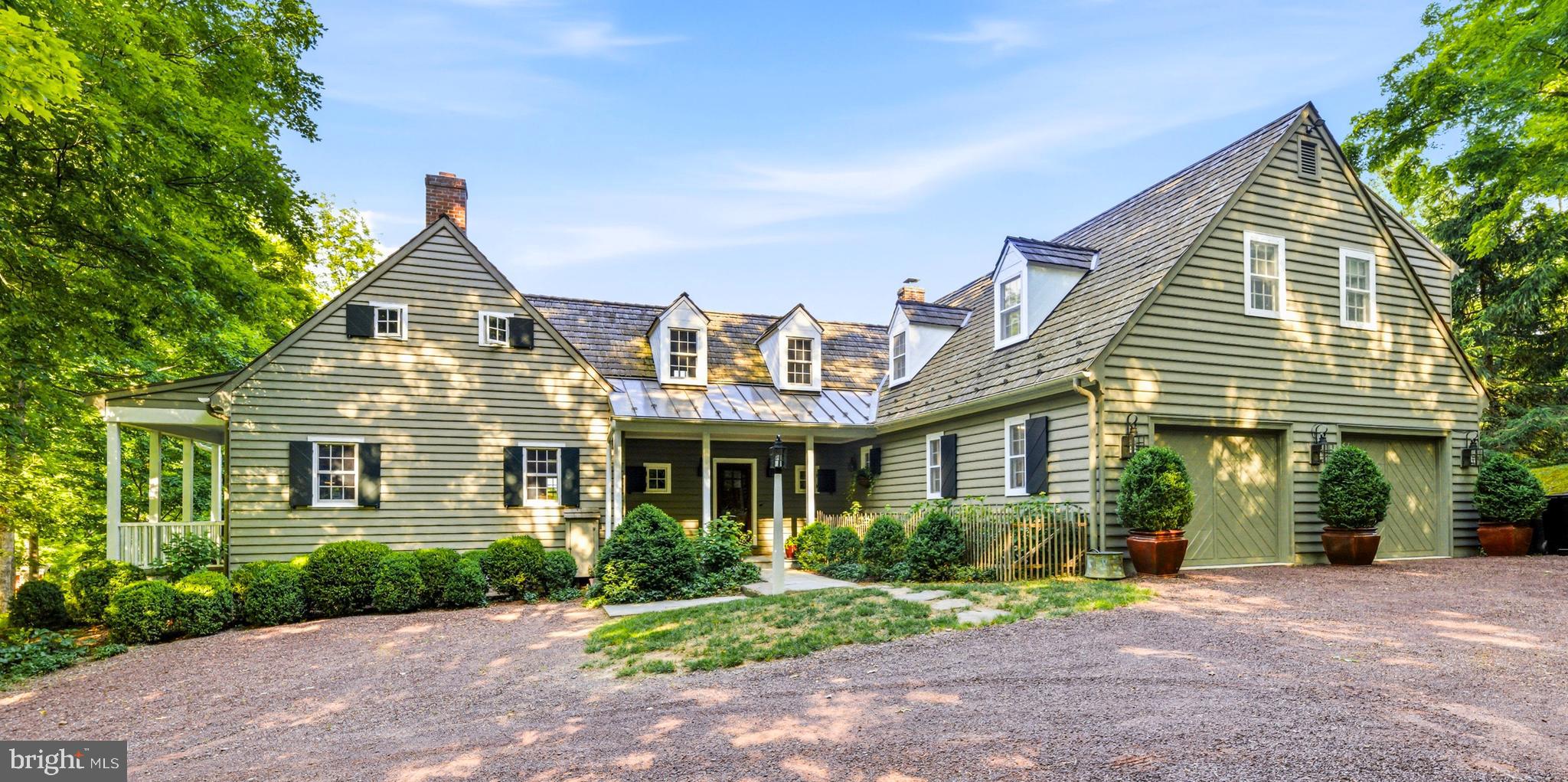 Ever dreamt of owning a home where timeless Colonial character, artisan craftsmanship and the rhythm of a wistful yet well maintained parish come together in remarkable harmony? This pristine residence is being offered for the first time. Tucked within the storybook surroundings of Carversville, a nationally registered historic village recognized for its preserved architecture and strong sense of community, this residence offers a rare opportunity to enjoy a slower pace without sacrificing modern comfort.  Known as "Stover Hill House",  this renovated and expanded carriage house was inspired by Williamsburg Colonial design and thoughtfully reimagined in a collaboration between the owners and acclaimed architect Ellen Happ, whose work is celebrated for seamlessly blending restoration with renewed purpose.  A welcoming approach framed by mature trees, perennial gardens, and rustic hardscape sets a tone for what awaits inside. Rich hardwood floors, shiplap accent walls, and exceptional millwork create warmth and character from the moment you enter. Natural light pours through generous windows in the living room, illuminating custom built-ins ready to showcase treasured collections. Gather around the fireplace for lively conversation or slip away onto a private porch overlooking the village, where an evening drink feels especially rewarding. The adjoining dining hall is designed for memorable entertaining, with French doors opening to a covered patio and sunlit veranda that invite relaxed afternoons outdoors. Nearby, the kitchen balances beauty and function with its ample cabinetry, a striking prep island with a countertop made of Cherry harvested from the property with bread board ends, premium stainless steel appliances, leathered granite countrtops, and a barn-door entrance leading to a thoughtfully planned butler's pantry. Upstairs, the primary retreat features a handcrafted Juliet balcony made by a local artisan, adding a distinctive touch to to the suite. Three more bedrooms provide comfortable accomodations, while several contemporary baths possess upscale finishes. An exceptional guest suite on the second floor adapts beautifully to changing needs, contributing its own kitchen, living room, dining area, and fireplace. Whether hosting extended visitors, as a multi-generational quarters, or furnishing flexible arrangements for remote work or hobbies, endless possibilities await. Beyond the home itself, a sanctuary where tranquility and beauty coexist with  lovely English gardens, meadow views, and established landscaping create an atmosphere that feels delightfully removed from the demands of the urban jungle. Additional highlights include a laundry nook, oversized two car garage, chicken coop with laying hens, and an active beehive producing fresh honey. Located mere steps from the celebrated Carversville Inn and within top-rated schools, you'll find Doylestown museums, boutiques, restaurants, and cultural attractions easily accessible, while Princeton and Philadelphia provide numerous options for entrtainment and recreation. Classic and intriquing, this residence offers a setting where history, craftmanship, and everyday life make something far more memorable than just a daily shelter. Come experience the story waiting to be continued!