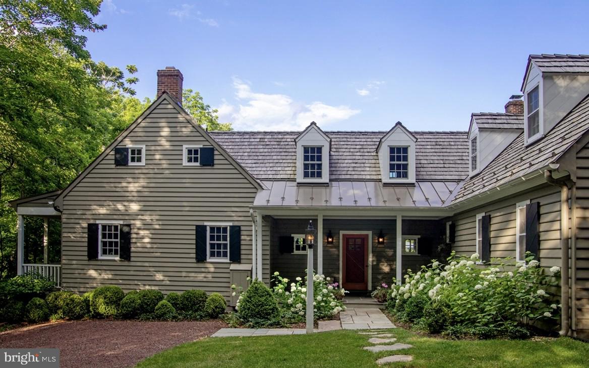 A rare opportunity is now available to own a home in the Historic Village of Carversville where an exceptionally designed structure reflects historic and current character. This pristine residence is being offered for the first time. Tucked within the storybook surroundings of Carversville, a nationally registered historic village recognized for its preserved architecture and strong sense of community, this residence offers a place to enjoy a slower pace without sacrificing modern comfort.  Known as "Stover Hill House",  this renovated and expanded carriage house was  inspired by historic design, built by well known craftsman Robert Johnson and thoughtfully reimagined for expansion in a collaboration between the owners and acclaimed architect Ellen Happ, whose work is celebrated for seamlessly blending restoration with renewed purpose.  A welcoming approach framed by mature trees, perennial gardens, and rustic hardscape sets a tone for what awaits inside. Rich hardwood floors, shiplap accent walls, custom made doors, craftsman hardware and exceptional millwork create warmth and character. There is abundant natural light throughout.  Gather around the fireplace for lively conversation or slip away onto  private porches overlooking the village. The open and comfortable sun-lit kitchen-dining-living space spills out through French doors to a handsome covered porch and flagstone patio surrounded by a lush meadow, garden with stone wall, birdhouses and apiary. The kitchen balances beauty and function with its ample custom cabinetry by Village Cabinetry, a striking prep island with a countertop made of Cherry harvested from the property, premium stainless steel appliances, including DCS commercial range and hood,  Liebherr refrigerator, honed and leathered granite countertops, and a barn-door entrance leading to a cute butler's pantry with it's own oven, sink, dishwasher and marble countertops. Upstairs, the master retreat features generous closets and a handcrafted  balcony made by a local artisan. The master bath feaures hand crafted dual sinks with marble tops. Three more bedrooms provide comfortable accomodations. A recenty renovated family/guest living area on the second floor connects with two bedrooms, full bath and rear staircase. Living area ammentities incude a bar sink, under-counter frig, dishwasher, washer/dryer, dining area, and wood burning fireplace-the space adapts well to extended family/visitors , remote work, or as a multi-generational quarters.  Beyond the home itself, a sanctuary where tranquility and beauty coexist with  lovely perenial gardens, meadow views, and established landscaping create an atmosphere that feels delightfully removed from the demands of the urban jungle. Additional highlights include a first floor laundry nook, oversized two car garage, and an active beehive producing fresh honey. Located mere steps from the celebrated Carversville Inn and Thyme and Plate catering  (open for eat-in or take out).  You'll find Doylestown, Stockton, and New Hope with museums, boutiques, restaurants, and cultural attractions easily accessible, while Princeton and Philadelphia provide numerous options for dining and entertainment.  This delightfully intriquing residence offers a setting where history, craftmanship, and everyday life make something far more memorable than just a daily shelter. Come experience the story waiting to be continued! And  don't forget that the New Hope Solebury School District is a top rated school system.