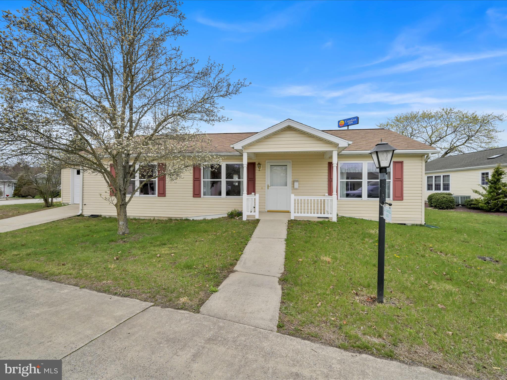 Welcome Home to Easy Living!!  Year round living or Summer "Snowbird" nest,  this desirable over 55 community offers a great opportunity for your next chapter!  Living in an over 55 community means more than just owning a lovely home - its about enjoying an active, social lifestyle!  Situated just 3/10 of a mile from Exit 100 (Pine Gove) on Interstate 81 makes commuting or traveling a breeze!  Designed with comfort, convenience & low-maintenance living in mind, this spacious 3 bedroom 2 bath home is a perfect fit for active adults looking to enjoy their days in a peaceful, friendly neighborhood enhanced by a clubhouse for community interaction & events.  A covered front porch offers a cozy spot to enjoy your afternoon tea or wave to your friendly neighbors. The open & inviting interior is both welcoming & functional.  Natural light creates a warm & inviting atmosphere throughout.  The kitchen with open dining area easily accommodates  gatherings of family or friends.   The laundry room includes a full size washer & dryer. The primary bedroom with ensuite bath is your personal haven.  Two additional bedrooms & a full bath are located on the opposite side of the home, offering privacy & comforts for guests.  A garage with auto opener adds parking convenience.  Whether you are downsizing, relocating, or simply looking for a simpler lifestyle without sacrificing comfort, this affordable ranch home checks all the boxes and allows you to age in place!   You've worked hard - now it's time to enjoy the fruits of your labor!!  Don't wait - schedule your private showing!