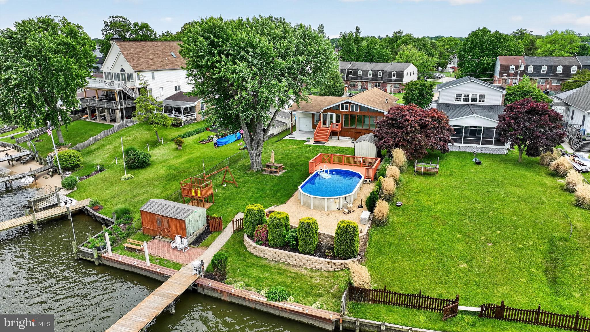 Welcome to this exceptional waterfront retreat at 152 Kingston Park Lane, where breathtaking Chesapeake Bay views meet comfort, space, and functionality. Situated on approximately a 1/4-acre lot, this beautifully maintained 3-bedroom, 2.5-bath home offers the perfect blend of indoor luxury and outdoor waterfront living.

Step inside to soaring cathedral wood ceilings that span the living room, dining room, and kitchen, creating a warm yet expansive feel throughout the main living area. The oversized kitchen is designed for entertaining and everyday convenience, featuring Corian countertops, a large center island, 42” cabinets, ceramic tile flooring, recessed lighting, double sink areas, two stoves with built-in microwaves above each, and an under-counter ice maker. Hardwood flooring adds timeless charm throughout much of the home.

The finished walkout basement provides additional living and entertaining space, while the pellet stove offers cozy comfort during cooler months. Outside, enjoy your own private waterfront oasis complete with a partially in-ground/above-ground pool, hot tub, attached 1-car garage, and a newly blacktopped driveway (2022) with parking for 6+ vehicles.

For boating enthusiasts, the private pier is fully equipped with electric and water service, two boat lifts, two Jet Ski lifts, a new bulkhead, and updated pier stringers. Deep water access makes this a dream setup for enjoying life on the Chesapeake.

Additional updates include a new roof in 2018 and owned solar panels installed in 2019 for energy efficiency and long-term savings. Two storage sheds with newer roofs provide even more flexibility and storage space.

Rarely does a waterfront property combine this level of functionality, updates, and panoramic water views — all in one incredible package.