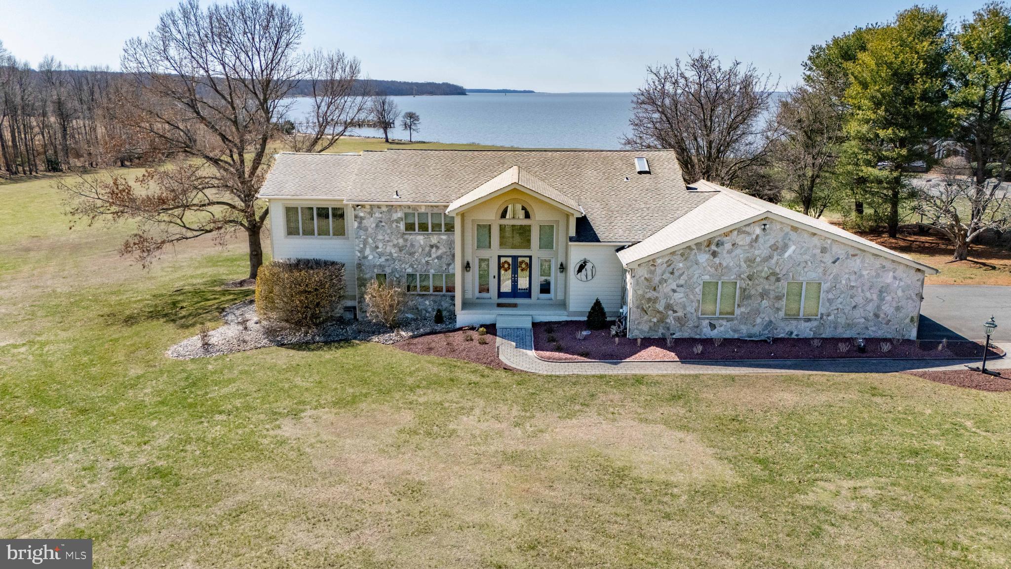 PANORAMIC WATERVIEWS!!!!   Breathtaking Panoramic Views – Renovated Waterfront Home

Experience the beauty of waterfront living in this meticulously maintained, renovated (2024) home in Earleville, offering over 3,500 sq. ft. of living space. Designed to capture unparalleled panoramic views from every room in the rear of the home, this 3-bedroom, 2.5-bath home features an open floor plan.

Step inside and be captivated by the breathtaking water views. The spacious living room boasts a floor-to-ceiling stone wall with an electric fireplace, seamlessly flowing into the stunning new kitchen with quartz countertops, brand-new appliances, a coffee bar, and a dry bar—perfect for entertaining. A sunroom and dining area provide the ideal setting to take in the serene surroundings, while custom blinds throughout the home enhance privacy and style. The main level also includes a luxurious owner’s suite and an additional bedroom or office space, both with spectacular water views.

A beautiful open staircase leads to the bright and spacious lower level, where a large family room with another floor-to-ceiling stone wall featuring an electric fireplace awaits. This level also features two generously sized bedrooms, a kitchenette, and direct access to the covered lower deck, offering even more stunning waterfront views. The layout makes this space ideal for guests or an in-law suite.

Extensive updates completed in 2024 include fresh interior and exterior paint, new landscaping, gutter replacement, two new HVAC systems, and brand-new kitchens and baths with high-end finishes. Outdoor living is enhanced with a spacious main-level deck featuring a retractable awning, providing comfort and shade, while the covered lower deck offers another perfect space to relax and enjoy the waterfront setting. The expansive lot offers plenty of room for an inground pool, making it ideal for entertaining and outdoor enjoyment.

Additional features of this exceptional home include custom blinds, central vacuum, a 3-car garage, a deeded boat slip with lift, and private beach access. Don’t miss this rare opportunity to own a turnkey waterfront retreat where luxury meets tranquility!