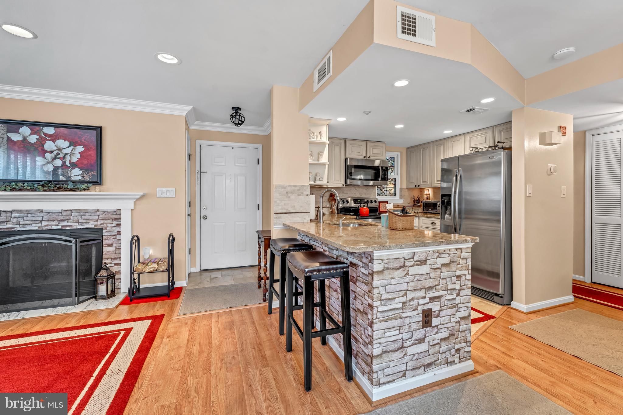 Stylish, updated, and perfectly positioned—this is the one you’ve been waiting for! Tucked away in a peaceful, park-adjacent setting, this ground-level condo offers the best of both worlds: nature at your doorstep and premier shopping, dining, and entertainment just minutes away at Crown, Rio, and Kentlands.  Inside, you’ll find a smart, functional layout with an upgraded kitchen featuring granite countertops, a charming wood-burning fireplace, and generous storage with walk-in closets. Both full bathrooms have been recently renovated and the HVAC system was replaced in late 2019. The home has been lovingly maintained and it shows—from the finishes to the overall condition.  Step out from your private patio and you’re just steps from walking trails, tennis courts, a community pool, and more. Commuters will love easy access to I-270, 370, and the ICC. Move-in ready, beautifully cared for, and perfectly located—this one checks all the boxes.