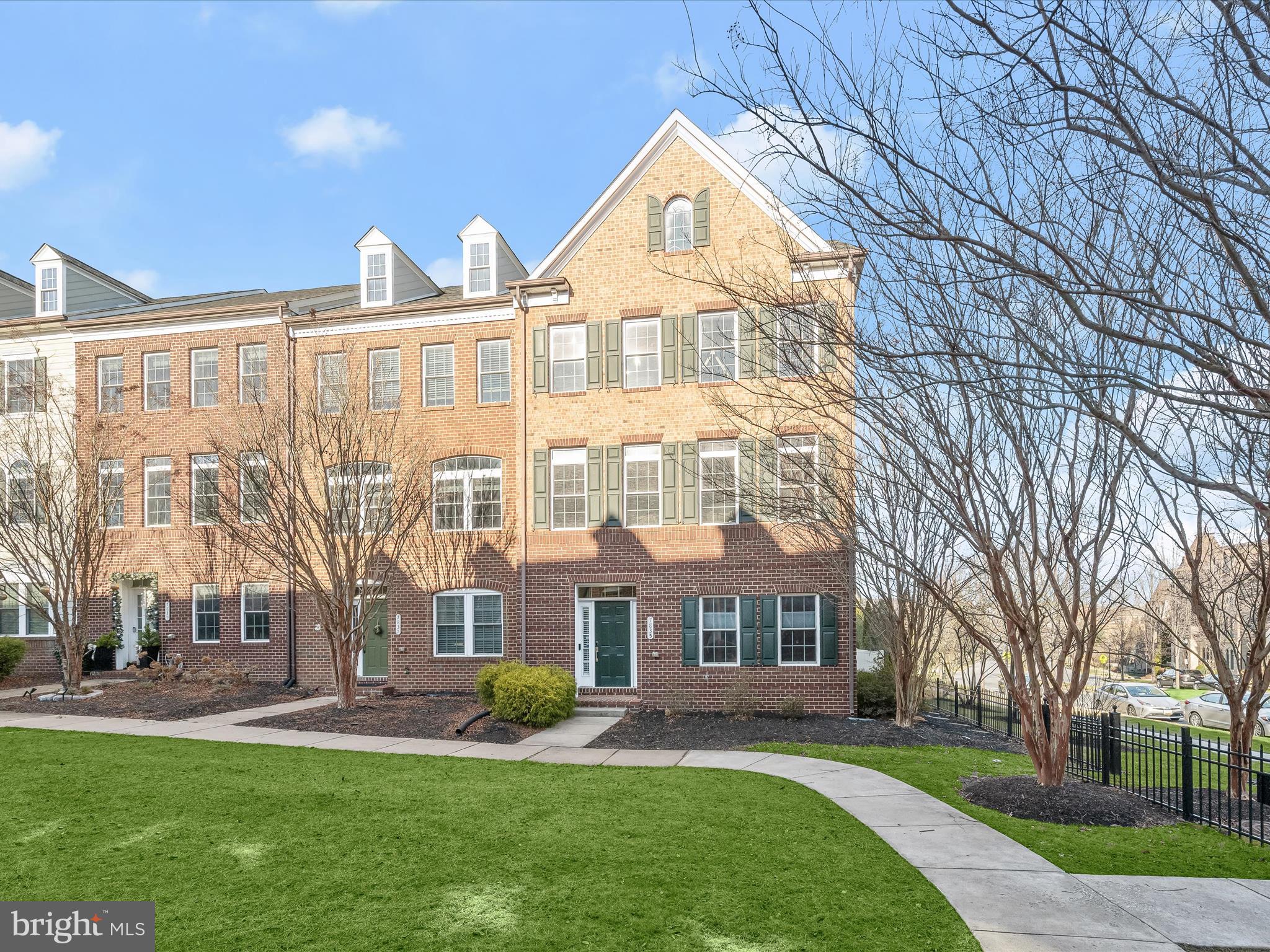 Welcome to this stunning, end-of-row townhome nestled in the heart of amenity-rich Maple Lawn. This exceptional residence boasts over 3,000 sq. ft. of living space highlighting luxurious finishes, exceptional design, an expansive deck and attached garage, with updates including recessed lighting using the Lutron smart system, plantation shutters, and ethernet ready.   The sun-filled main living and dining areas are adorned with hardwood floors, accent molding, and centered around a striking dual-sided gas fireplace—perfect for both intimate evenings and grand entertaining.  You'll love preparing your favorite meals in the gourmet kitchen featuring a custom mirror and glass backsplash, quartz countertops, stainless steel appliances, and 42-inch cabinetry, and adjoining breakfast room. The oversized island invites gatherings, while the adjacent family room opens to a private deck offering a custom remote-controlled retractable awning, creating the ideal indoor-outdoor flow.  Retreat to the expansive primary suite, showcasing an impressive tray ceiling and includes a spacious walk-in closet and a spa-like en suite bathroom with a soaking tub, oversized glass-enclosed shower, and dual granite vanity.  Two additional generously-sized bedrooms, a hall bath, and a convenient laundry room complete the upper level.  The entry level offers versatility with a home office or flex space, enclosed by charming glass French doors, along with interior access to the garage for added convenience and a bonus room with a bath rough-in or perfect for added storage.  Maple Lawn residents enjoy unparalleled amenities, including a resort-style swimming pool, state-of-the-art clubhouse with fitness rooms, sports courts, playgrounds, and much more.  This home is a rare gem—don’t miss the opportunity to live in one of the most sought-after communities!