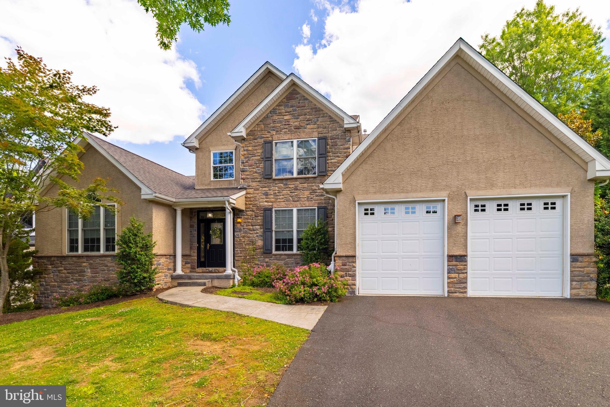 Tucked away on a quiet cul-de-sac of just twelve homes, this thoughtfully designed home offers the convenience of first-floor living, flexible spaces for today's lifestyle, and a location that places shopping, dining, recreation, and commuter routes within easy reach. Situated on a beautifully landscaped half-acre parcel, the home enjoys a peaceful setting while remaining just minutes from Routes 309 and 73, providing convenient access to Flourtown, Fort Washington, Chestnut Hill, Montgomeryville, Ambler, and everything in between. Designed with comfort and functionality in mind, the home offers nearly 3,700 square feet of living space, including a sought-after first-floor Owner's Suite, two additional bedrooms and loft on the second level, and a finished walk-out lower level. A welcoming foyer opens to spacious living areas that can easily adapt to a variety of needs. The living room offers flexibility to serve as a home office, library, music room, conversation area, or quiet retreat, while the dining room provides generous space for everyday meals, holiday celebrations, and gatherings with family and friends. At the center of the home is the family room, where vaulted ceilings, large windows, neutral décor, and a gas fireplace create an inviting space for everyday living. Open to the kitchen, it is easy to imagine family and guests naturally gathering here.
The kitchen is both practical and inviting, featuring a center island for casual meals, a separate breakfast area, abundant cabinetry, generous counter space, recessed lighting, and quality appliances. Whether preparing a quick breakfast or hosting a weekend gathering, the layout is designed to accommodate both.
Privately situated on the main level, the Owner's Suite is thoughtfully designed to provide comfort and convenience. Enter through the spacious sitting room before continuing into the bedroom with volume ceilings, two walk-in closets, and a well-appointed bath featuring separate vanities, a soaking tub, walk-in shower, and the added comfort of a heated bathroom floor. The main floor is completed by a powder room, laundry room, and convenient access to the attached two-car garage, making daily routines effortless.
The finished walk-out lower level expands the home's living space considerably and offers endless possibilities for recreation, media, hobbies, exercise, or entertaining. A wet bar with powder room, high ceilings, and abundant storage make this level equally functional and enjoyable. Sliding glass doors lead to the paver patio and rear yard, creating an ideal setting for outdoor dining, gardening, or simply relaxing outdoors. Additional features include a whole-house generator that is professionally serviced annually, providing peace of mind and uninterrupted comfort throughout the seasons. The home is also enhanced by hard-wired window candles throughout, creating a warm and welcoming appearance that is especially beautiful during the holidays while adding charm and curb appeal year-round. While perfectly suited for those seeking the convenience of first-floor living, the home's additional bedrooms, loft space, and finished lower level provide flexibility that appeals to a wide range of buyers and lifestyles. Adding to its appeal, the property is located within the highly regarded Springfield Township School District and is conveniently located near several respected private schools, including La Salle College High School, Springside Chestnut Hill Academy, Mount Saint Joseph Academy, and Gwynedd Mercy Academy.  Combining a desirable floor plan, comfortable living spaces, a peaceful cul-de-sac setting, and exceptional convenience, this is a home designed to be enjoyed for years to come.
