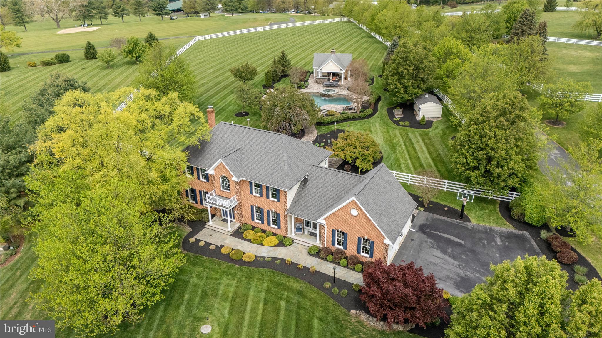 Peace, Perfection, and Unmatched Craftsmanship in Mount Airy's Premier Golf Course Community of Challedon.

This is one of the most exceptional homes you'll find in all of Mount Airy. Every detail has been thoughtfully updated, and the pride of ownership is evident from the moment you arrive. This immaculate property offers a perfect blend of elegance, comfort, and outdoor enjoyment.

Curb appeal is immediate and striking. A slate walkway leads to a beautiful front entry, setting the tone for what lies beyond. Step into the foyer and the story of this home begins to unfold. To the left, a handsome office with a bay window overlooks the sweeping front yard and offers views of the golf course in the distance. Ethan Allen furnishings convey, providing a turnkey workspace with room to spread out. To the right, the living room features expansive views and flows into a formal dining room crowned by a gorgeous tray ceiling. A sliding door opens to an intimate covered front porch—an elegant setting for holidays and special gatherings.

The kitchen is designed for both function and beauty: custom white cabinetry, granite counters, stainless steel appliances, and a large island perfect for meal prep and casual conversation. The adjacent breakfast  room features a dramatic cathedral ceiling  and opens to the mahogany deck and the spectacular backyard beyond. The family room radiates warmth with plush carpet and a cozy fireplace that anchors the space, while multiple windows frame views of the backyard oasis. A laundry/mud room off the kitchen provides garage access, and a powder room near the foyer completes the main level.

Pristine plush carpet flows throughout the second floor. The primary suite is a true retreat featuring a tray ceiling, a large walk-in closet with a custom organization system, and a spa-inspired en-suite bath with soaking tub, dual-sink vanity, and a sleek marble-walled shower. Three generously sized secondary bedrooms share a hall bathroom with a marble-walled shower and dual-sink vanity.

The finished lower level delivers even more space for entertaining and everyday life: an open recreation room with dedicated areas for media, billiards, and games; a separate exercise room; a guest bedroom with full bathroom featuring a walk-in tiled shower; plus a bonus room, large storage room, and utility room. Walk-up stairs lead to the backyard.

This is where the magic happens. Step from the mahogany deck onto a flagstone patio with space for outdoor dining and a conversation nook. Beyond, the pool deck surrounds a heated, saltwater pool with a pebble-tec finish and self-cleaning system—plenty of room for lounging. A hot tub flows seamlessly into the pool, extending the relaxation. The pool house features a covered patio with a vaulted ceiling and floor-to-ceiling stone fireplace, creating the perfect setting for evenings outdoors. Inside, you'll find a half bath, storage room, and entertainment bar with sink. The entire backyard is enclosed with vinyl board and wire fencing—safe for children and pets—and backs directly to the 9th hole of Challedon Golf Course, with views of the fairway and breathtaking Mount Airy sunsets. Professional landscaping polishes every corner with beauty and grace.

Mount Airy is known for its small-town charm, nice restaurants and shopping, and close proximity to I-70 and commuter routes. Come experience the luxury and tranquility of this exquisite home. Opportunities like this don't come along often. Schedule your private showing today.