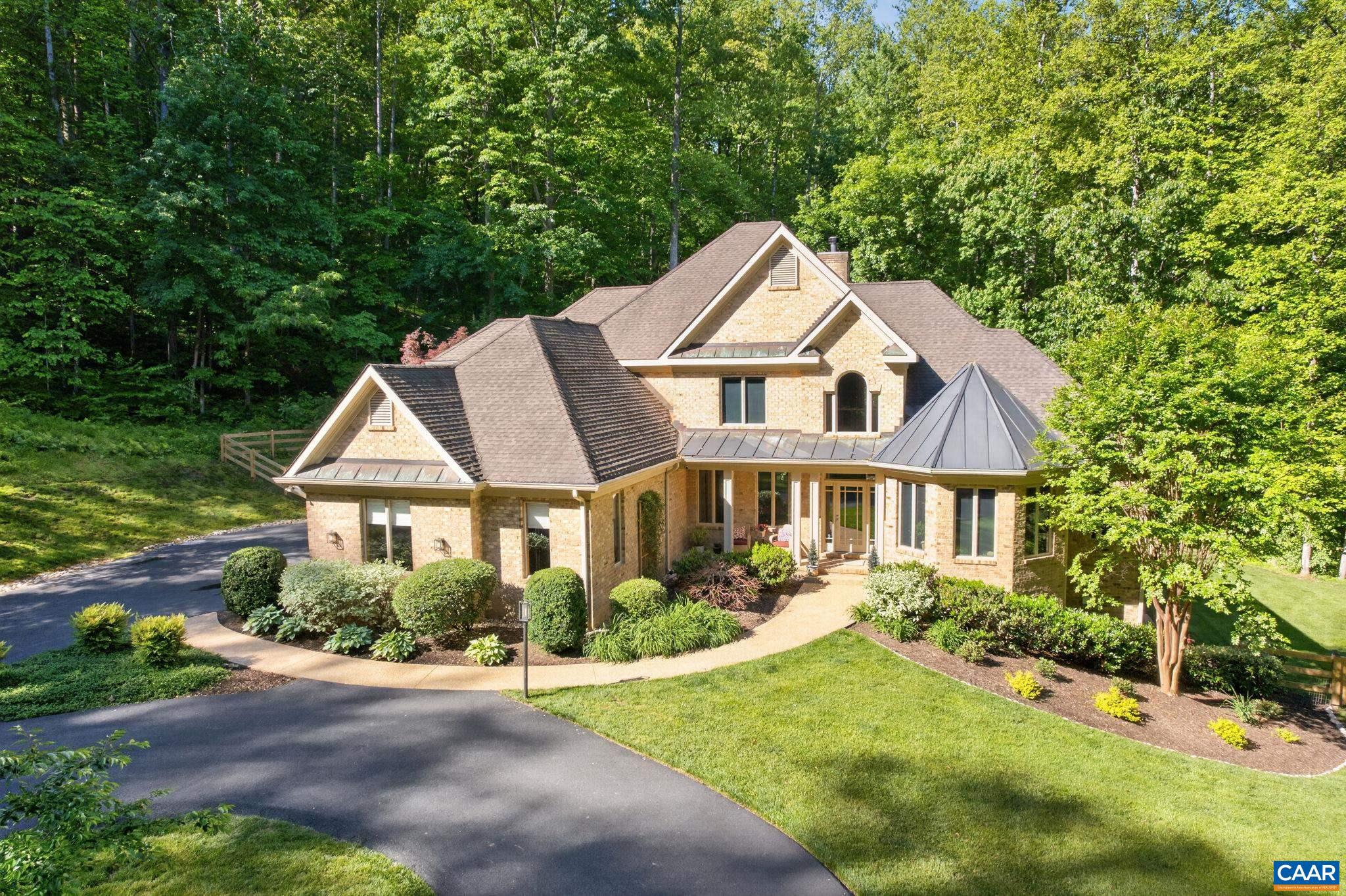 Meticulously designed 4 bedroom, 3.5 bath home privately sited on 21 wooded acres in the Murray Elem. district. The natural-light-drenched home features gracious main floor living with fresh paint, refinished floors, stunning two story family room with wood/propane fireplace, hardwood floors/doors/trim, tiled baths, home office, generator, 3 car garage, fiber internet. Gourmet kitchen opens to the family room/screen porch/deck and features a 48" Viking cooktop, Thermador wall oven/microwave/warming drawer, Bosch dishwasher, wine cooler, cherry cabinets, expansive granite counter space, island and breakfast bar, pantry and plenty of storage. A wonderful area to cook and to entertain family and friends! Primary suite with sitting area, deck access, bath with his-n-hers shower, dual granite counter vanities, jetted soaking tub, dual walk-in closets with built-ins. Additional upstairs bedrooms and loft. Terrace level exercise room and rec room, workshop and lots of storage space. Lovely landscaped grounds features garden pond with waterfall, new wooden fence, invisible fence, outdoor shower, new circular paved drive. And just minutes to Western schools and Crozet shopping/dining, and less than 15 minutes to UVA and Charlottesville!,Cherry Cabinets,Granite Counter,Fireplace in Family Room