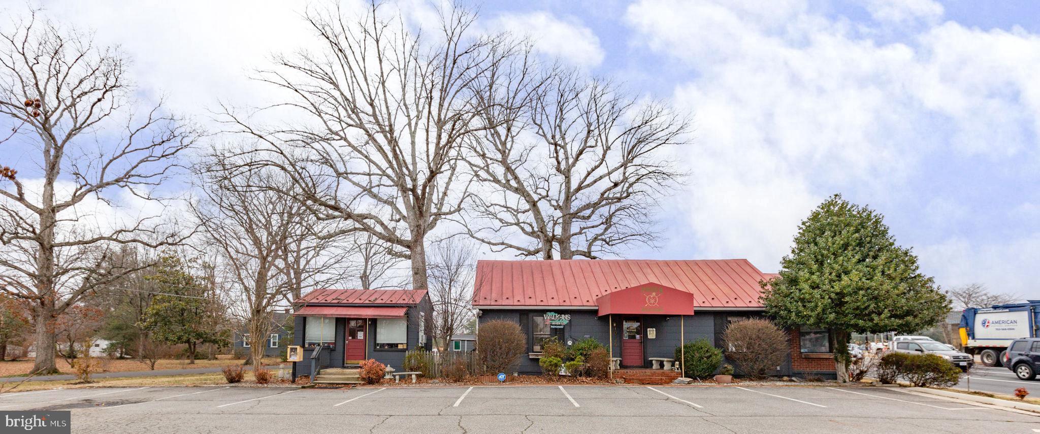Versatile, upgraded commercial property positioned at the signalized
hard corner of Courthouse Road (Route 208) and Hood Drive in
Spotsylvania County. This two-building offering combines strong
exposure, natural light, and flexible layouts making it ideal for retail,
office, medical, studio, or professional service users.
The main Building underwent a thorough renovation in 2020 with a
new HVAC system installed in 2022. The primary structure features
three open and versatile rooms, a welcoming reception area, kitchen,
and restroom. Currently operating as a tattoo and art studio, the
space easily adapts to boutique retail, salon, wellness, counseling,
design, or general office use. Large front display windows and
additional windows throughout create an inviting, light-filled
environment while maximizing street visibility. 
A second detached studio offers a private, single-room layout with its
own bath—perfect for an executive office, treatment room, studio, or
rental suite. Oversized windows enhance visibility and create a bright,
professional setting. If you need more space, Seller has plans for
construction of another Building on site.  
Situated along a primary commuter corridor with convenient access
to I-95 and Route 1, the property benefits from steady daily traffic and
proximity to dense residential areas, neighborhood retail, and the
Fredericksburg VA Health Care Center.