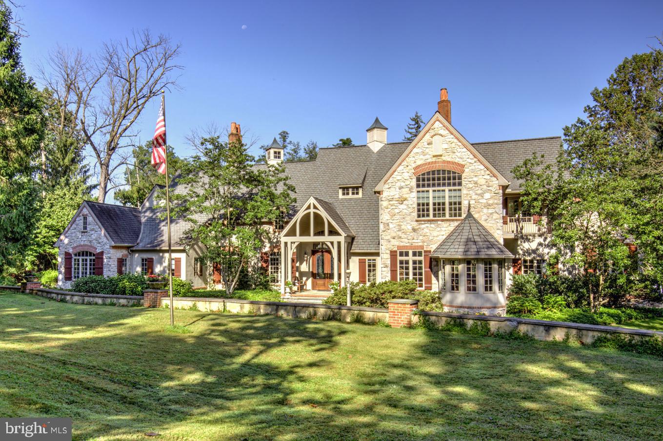 Exceptional one-owner custom estate built by Steve Edris, gracefully situated on 5.6 private acres in sought-after Lancaster Township. Enjoy a secluded setting with Conestoga River frontage, offering exceptional privacy while remaining just minutes from downtown Lancaster. Thoughtfully designed and meticulously crafted, this impressive two-story residence offers approximately 5,935 square feet of refined living space on the main two levels.
An impressive entrance foyer with marble and limestone flooring sets the tone, featuring a two-story open turned staircase. The expansive great room showcases white oak hardwood floors, a masonry Rumford hybrid fireplace (propane or wood) with custom mantel, and elegant architectural detailing including built-in cabinetry, picture-frame molding, and decorative cornices. A distinctive turret-style library with custom shelving overlooks the great room and is connected by an interior walkway and dual staircases, creating both visual interest and functional flow throughout the home.
Designed for both everyday living and entertaining, the home also offers a family room and game room featuring custom TV cabinetry, built-in bookshelves, and window seating with storage. A unique game-table turret provides an inviting space for dining or gatherings. Flooring throughout these areas is custom sycamore, milled from trees originally located on the property—an exceptional detail that underscores the home’s thoughtful craftsmanship.
The custom Colonial Craft kitchen is both expansive and highly functional, offering abundant cabinetry, granite countertops, and a custom built-in hutch with extensive storage. Premium appliances include Sub-Zero, Bosch, Thermador, Gaggenau, and KitchenAid. A large center island provides a prep sink and cooking station, while pillowed limestone tile flooring adds warmth and character. A walk-in pantry with custom shelving enhances organization. A wall of windows frames serene views of the wooded grounds and entry drive, making this kitchen a true focal point of the home.
The first floor is completed by a theater room with an 8' x 4.5' projection screen, a private office with exterior entrance, and a powder room featuring a built-in bench and storage. A functional mudroom area includes walk-in storage. The attached three-car garage offers a large work/wood shop, ideal for hobbies or storage.
Upstairs, the primary suite provides a private retreat, featuring a propane fireplace with custom mantel, French doors leading to a balcony, and a spacious walk-in closet with custom built-ins. The en-suite bath includes a jetted tub, large glass shower, and separate his-and-her vanity areas. Bedroom two is an en-suite with private bath, vaulted ceiling, walk-in closet, and window seat with storage. Bedrooms three and four share a Jack-and-Jill bath with double vanities and individual walk-in closets. A conveniently located laundry room with storage completes the upper level.
An exercise room with sauna, easily adaptable as a potential fifth bedroom, adds further flexibility. The home also includes a partially finished basement, offering additional recreational or storage space.
Outdoor living is equally impressive, featuring a two-level rear patio and an in-ground swimming pool, perfect for entertaining or relaxation. The property also includes a three-car detached pole barn, ideal for equipment, tractors, or additional vehicle storage.
Custom designed and built in 1999 by the current owner, the home includes numerous upgrades such as propane radiant hot-water floor heating with 11 zoned circulators, two central air-conditioning systems, and two 1,000-gallon buried propane tanks. Public water and sewer service the property.
A truly one-of-a-kind custom estate, offering privacy, architectural distinction, and exceptional craftsmanship throughout—an extraordinary opportunity in Lancaster Township.