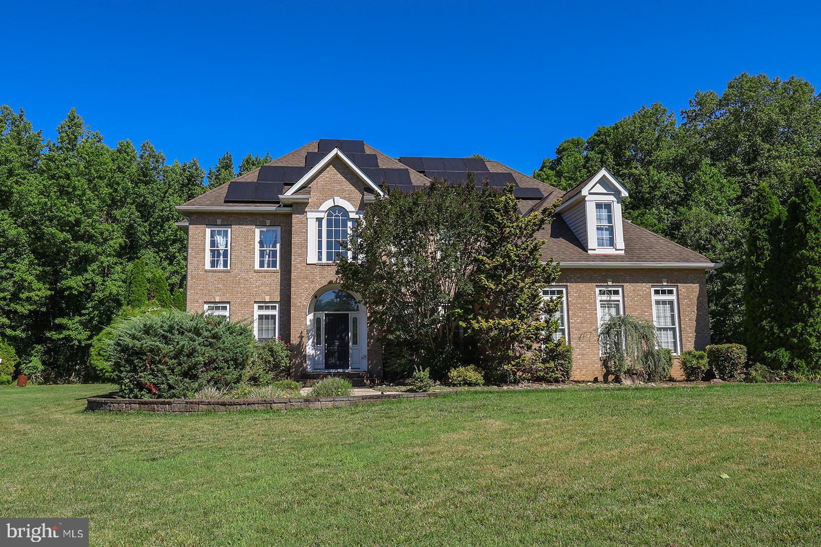If you've been looking for privacy, space, and a home that truly stands out, this is one you don't want to miss. Tucked away on over two beautiful acres with no HOA, this custom home offers the peaceful feeling of country living while still being just minutes from everything Prince Frederick has to offer.
From the moment you step inside, you'll appreciate the soaring two-story foyer, gorgeous hardwood floors, and thoughtful layout designed for both everyday living and entertaining. The main level features a private bedroom with a full bath that's perfect for guests, an in-law suite, or a nanny.
The kitchen is truly the heart of the home and a dream for anyone who loves to cook or entertain. It includes Wolf double ovens, a massive GE Monogram refrigerator, two dishwashers, double pantries, a gas cooktop with warming drawer, food steamer, cup warmer, bar sink, wine refrigerator, and an oversized island with plenty of seating. There's even direct access from the garage to make unloading groceries a breeze.
The two-story family room is filled with natural light and centered around a beautiful fireplace, while the formal dining room is ready for holiday gatherings. A private office with built-in bookcases provides the perfect work-from-home space.
Upstairs, you'll find four spacious bedrooms, including an incredible owner's suite complete with a tray ceiling, oversized walk-in dressing room, luxurious bath with double vanities, towel warmers, soaking tub, and separate shower. The adjoining sitting room overlooks the backyard oasis, offering breathtaking views of the pool, patio, and mature landscaping. Even the laundry room is conveniently located just outside the owner's suite.
The finished lower level offers even more living space with a stunning custom teak bar, room for a home gym or second office, additional living area, plenty of storage, and walk-out access to the backyard. A half bath is already in place with room to add a shower if desired.
Outside is where this property really shines. Relax by the beautiful pool, entertain on the expansive paver patio, unwind on the screened porch, or gather around one of the fire pits. The detached workshop is wired for electric and is the perfect place for hobbies or extra storage.
Additional highlights include an oversized three-car garage, in-floor electrical outlets throughout the home, and owned solar panels.
Homes like this rarely come along—offering luxury, privacy, and exceptional indoor and outdoor living all in one incredible property.