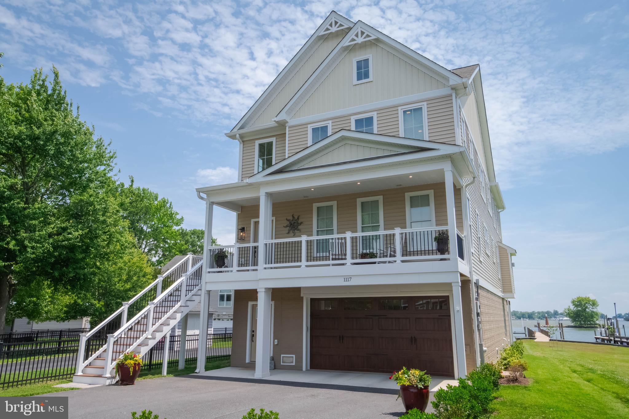Discover unparalleled waterfront living at 1117 Chester Road, nestled in the coveted Long Beach Estates of Middle River. This stunning 2,600+ square foot residence offers three bedrooms and three and a half bathrooms, all set against breathtaking views of Galloway Creek, mere moments from the Chesapeake Bay.

Step inside to a dramatic two-story foyer and high ceilings that lead you into a thoughtfully designed living space featuring a cozy gas fireplace. The kitchen shines with elegant quartz countertops and modern appliances, creating a functional and inviting space for everyday living and entertaining. Enjoy seamless indoor-outdoor living with direct access to a spacious deck, ideal for enjoying the serene surroundings.
The main level features a luxurious primary suite, offering comfort and privacy. In addition to the finished living area, the home offers approximately 500 square feet of unfinished space with an existing full bathroom, providing exceptional potential for a future recreation room, guest suite, home office, gym, or additional living area.

Experience the ultimate in waterfront amenities with your private pier, boasting navigable water, a dedicated boat lift, and a jet ski lift. Additional conveniences include an inviting front porch and an oversized two-car garage. This exceptional property combines elegant design with a vibrant waterside lifestyle. Schedule your private tour today and envision your next chapter.