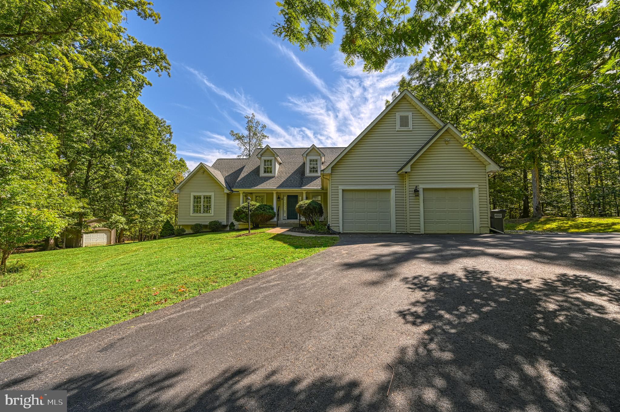 Experience elevated waterfront living on the private side of Lake Anna with this expansive 3BR/3BA retreat set on 2.357 acres. With over 3,800 sq. ft., this home is thoughtfully designed for both everyday comfort and effortless entertaining, featuring an open-concept layout, multiple gathering spaces, and a nearly fully finished walk-out basement complete with a gym/barre studio, flex space, and a full-size pool table that conveys, along with dedicated unfinished areas for a workshop, storage, and mudroom functionality.
Crafted with intention, the home offers true main-level living, including laundry, and enhanced accessibility with solid-core 36” doors (ADA-compliant) throughout. The primary suite is a private retreat with dual closets (including a walk-in) and a spa-inspired bath featuring a deep soaking tub and a low-threshold walk-in shower with grab bars and a fold-down teak seat.
Natural light fills the home through upgraded Pella low-E windows and doors, including sliders in the dining room and primary suite, as well as French doors with internal blinds in the lower level—blending energy efficiency with refined design.
Step outside to take in serene lake views and direct waterfront access. The private boathouse is fully equipped with electric, water hydrant, a tritoon pontoon lift, jet ski lift, and secure storage—designed for effortless lake days. A 12x20 shed with overhead storage adds even more functionality for outdoor and recreational needs. Community boat ramp access included.
For those seeking a legacy property, the sellers offer the rare opportunity to purchase the adjacent 1.89-acre waterfront lot (MLS# VALA2008684), creating the potential for a private compound or expanded lakefront estate.