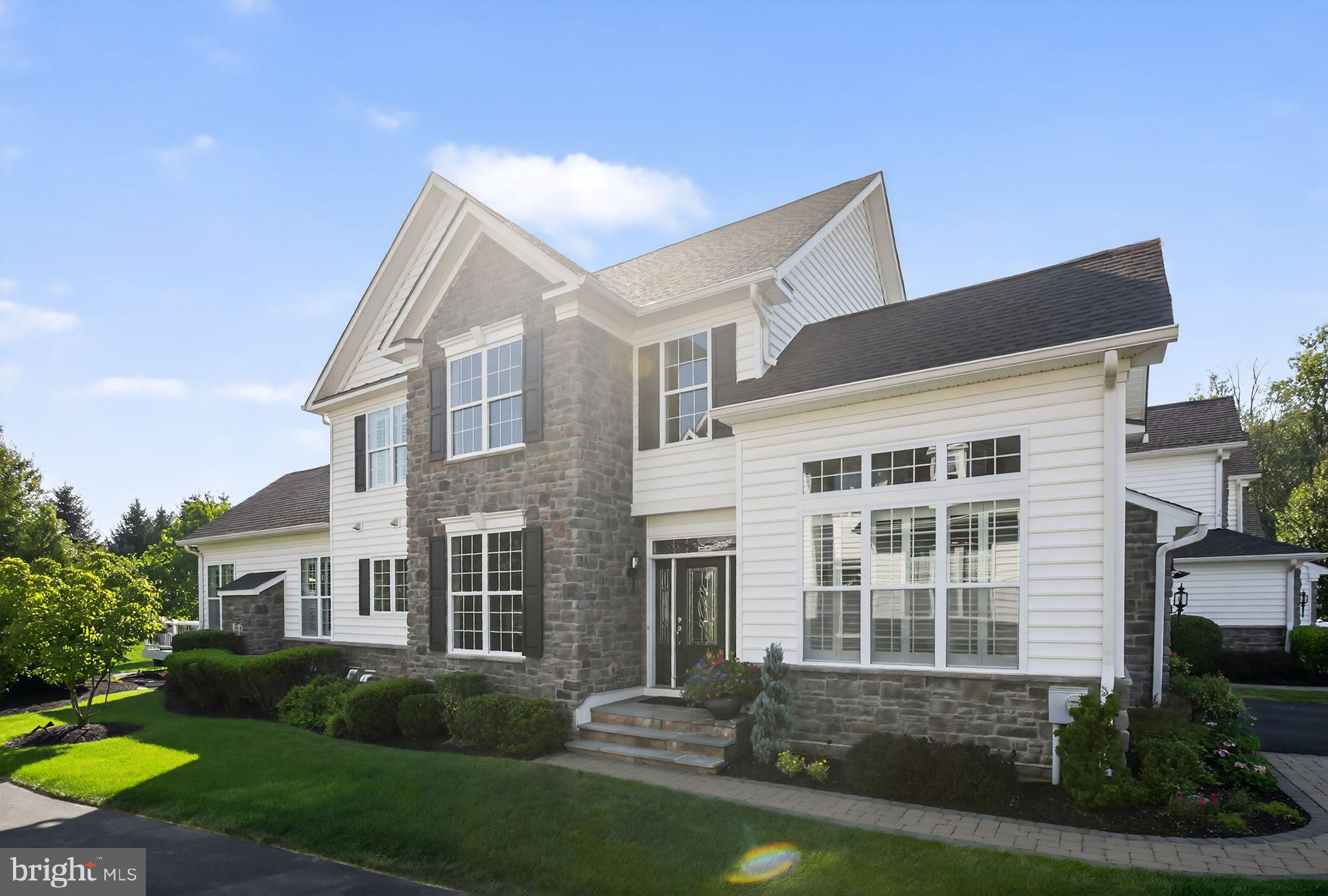 Welcome to 69 Hillyer Lane, a stunning End Unit carriage home located in the highly acclaimed The Enclave at Upper Makefield, a desirable active adult community. This Bucknell model, located on a cul-de-sac, offers an open floorplan with sophistication and style, setting the tone for the quality of craftmanship and ease of functionality. Upon entering this lovely home, you are enveloped by a dramatic two story foyer with elegant wooden stairs and upgraded balusters to the second floor. The main level has hardwood flooring, crown molding, and plantation shudders throughout. Off the foyer to the right is the sun-filled study with vaulted ceiling and architectural windows. The stylish gourmet kitchen is enhanced by granite countertops, white cabinetry, and a large contrasting island with cabinets. The well thought out large panty has built-in shelving and pullout drawers. The tiled backsplash is a stunning accent. A suite of stainless-steel Kitchen Aid appliances including a cooktop, combination wall oven/microwave make meal prep a dream. While enjoying your meal, reach into the built-in wine cooler at the butler’s pantry. 
The kitchen opens to the great room with an updated gas fireplace surrounded by floor to ceiling exquisite stack stone. The cathedral ceiling’s crown molding and additional decorative trim, along with the mood changing up lighting, offers you a unique experience in living well. 
From the great room you enter the spacious main floor primary bedroom. Both the great room and the primary bedroom are the expanded Bucknell, which adds precious square footage. The bedroom has a tray ceiling, ceiling fan and an ensuite spa-like bathroom with radiant heated tiled floor, dual vanities, an expansive, beautifully tiled shower with seat, and a large walk-in closet with motion sensor lights and custom built-ins. Rounding out this floor is the powder room with beautifully artistic tile work and the large laundry room complete with sink and plenty of wall cabinets. 
Also, from the great room you can step outside to your Trex deck or paver patio and enjoy the very private, park-like surroundings. The only things you see and hear in your backyard are trees, birds, and deer.
Upstairs you will find a spacious open loft offering additional living space or another office, with views of the main level. Two large bedrooms and a jack and jill bathroom with two dual vanities complete the second floor. 
A finished, expansive, carpeted lower level offers unlimited possibilities with fantastic storage and plumbed for additional bathroom. Additional home amenities include a 2-car garage, reverse osmosis water treatment, whole house Aprilaire humidifiers, and multi-zone HVAC. This stunning home shows like a model and is move-in ready. Enjoy maintenance free living! A short drive to Newtown Boro, New Hope or Yardley for fabulous shopping and dining along with easy access to the I-295/95 corridor. 30 minutes to Princeton, 45 to Philadelphia and 90 minutes to the Jersey Shore and Manhattan.  See our Virtual Tour link for this home.
