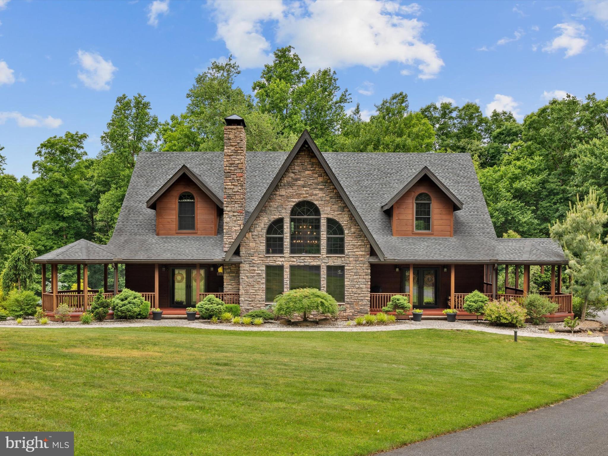 Spectacular Custom-Built Home Set on 60 Acres of Secluded Land! This hidden gem offers a peaceful retreat away from the hustle and bustle, surrounded by stunning natural beauty. Upon arrival, you'll be captivated by the tranquility and serene ambiance of this home. Enter through the front door to discover a spacious interior with striking post and beam construction. The main floor welcomes you with warm pine floors that extend seamlessly throughout the home. The great room's large distinctive windows flood the space with natural light, showcasing the exposed stone walls and elk antler chandelier. The gourmet kitchen is a chef's dream, featuring custom handmade cabinetry, high-end Viking appliances, a commercial range, an ice maker, a wine cooler, and elegant granite countertops. Adjacent to the kitchen, the octagonal breakfast room offers breathtaking views of the woodland surroundings. Step outside to your private haven, where a 35 x 18 screened-in porch invites you to relax in the gentle breeze. The primary bedroom on the first floor is a serene retreat, boasting a log beam ceiling, two walk-in closets, and a luxurious private bathroom. Upstairs, two spacious bedrooms offer privacy, along with an additional loft that extends the living space and is perfect for an entertainment area. Descend to the basement, which is already roughed in and framed for a future bath and expansive bar area. But that's not all! Auto enthusiasts will delight in the 100' x 50' outbuilding with heated insulation and radiant floor heat, offering space for up to 16 cars or any other storage needs. Wildlife lovers will appreciate the abundance of deer and turkeys roaming the property. If you're seeking a unique property immersed in nature, perfect for hiking, hunting, or simply enjoying the outdoors this is a rare find and close proximity to major arteries (just 10 minutes from the Pennsylvania Turnpike). Experience this property for yourself and schedule your showing today!