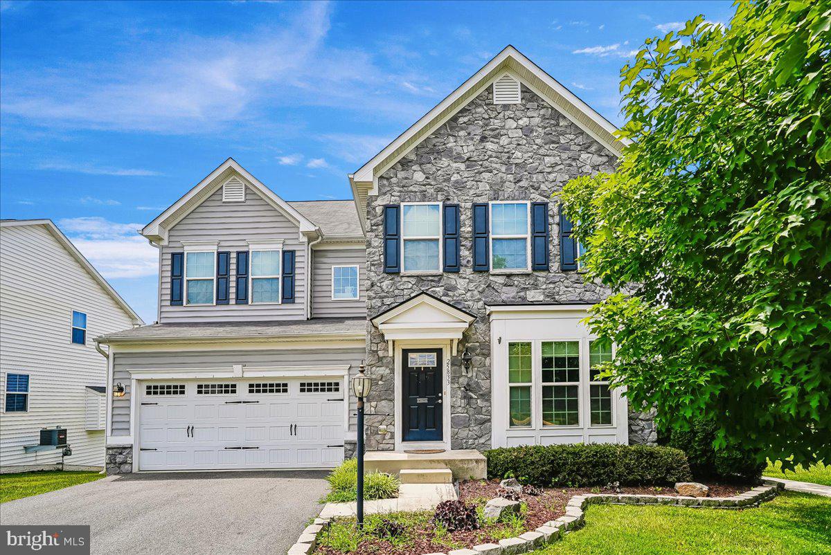 Welcome to this stunning Torino model in the highly sought-after Virginia Manor community, perfectly situated on a premium end-of-block lot. With over 5,293 finished square feet, this impressive Ryan Homes floor plan is one of the largest in the neighborhood and offers an exceptional blend of luxury, comfort, and functionality.

The beautiful stone-front exterior and covered portico create outstanding curb appeal. Inside, the open-concept floor plan is ideal for both everyday living and entertaining. A spacious mudroom leads to an oversized pantry and gourmet kitchen featuring newer appliances, double wall ovens, a massive granite island with abundant storage, and a convenient sitting area. The kitchen flows seamlessly into the bright two-level morning room extension with cathedral ceiling and opens to a large deck—perfect for enjoying morning coffee or evening gatherings.

The main level also features tile flooring throughout, a private office, formal living room, and a large great room anchored by a cozy stone fireplace. Upstairs, the luxurious primary suite offers a tray ceiling, two expansive walk-in closets with custom organizers, and a spa-like bath with dual vanities, soaking tub, and separate shower. A convenient bedroom-level laundry room serves all four bedrooms. One secondary bedroom features a private en-suite bath, while two additional bedrooms share a full hall bath. Most secondary bedrooms include customized closet storage systems.

The finished walkout lower level is filled with natural light and includes a spacious recreation room, full bathroom, and morning room extension with full-size windows. Luxury vinyl plank flooring enhances the lower level's appeal.

Additional features include a large two-car garage, crown molding, ceiling fans throughout, energy-efficient upgrades, irrigation system, rear access sidewalk, and abundant storage throughout the home.

Virginia Manor offers outstanding community amenities, including 14 parks connected by scenic walking trails, four tot lots, and access to two large swimming pools. Conveniently located near shopping, Route 50, Braddock Road, and Gum Spring Road, this exceptional home combines luxury, space, and convenience in one of the area's most desirable communities.