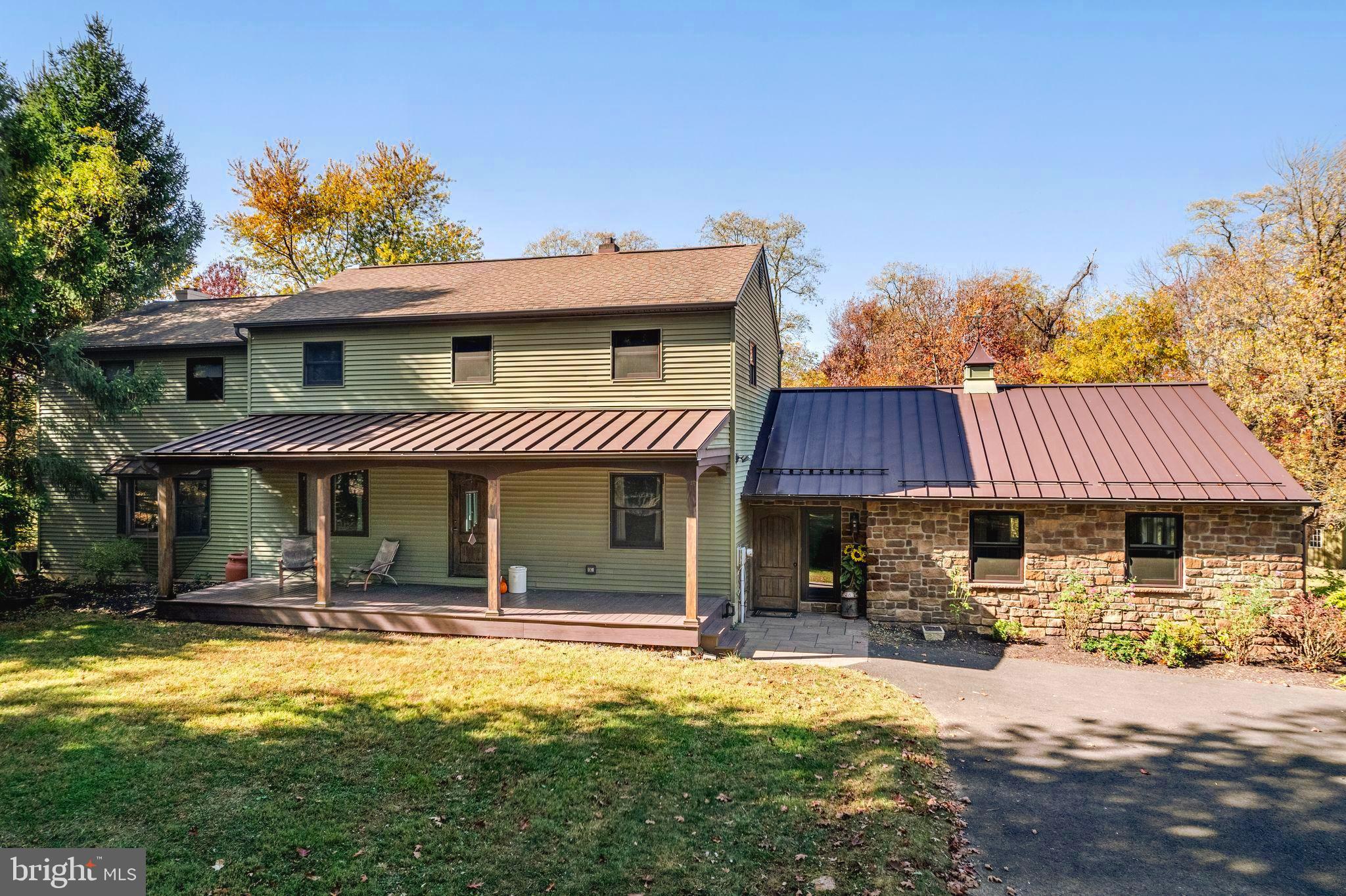 Private & convenient, a rare find tucked down a quiet lane on over 2 acres of natural serenity yet SO close to the heart of Newtown Boro and all its convenience. Only 4.5 miles to I-295. Exceptional Council Rock Schools. This one of a kind, custom 3700 sqft. home has 4 bedrooms, 2.5 updated baths. A circular driveway leads to the detached, oversized 3 car garage with a 2nd story of additional floored space up the stairs. Endless possibilities for its use. Amenities include public water/sewer, low taxes. A spacious entry welcomes you to relax and dine together in the large family room with solid wood, radiant heated flooring surrounded by windows to bring your private, natural surroundings to you. Just imagine gathering for holidays, watching a game or movie with room for everyone. The entry seamlessly connects the family room, mud room, morning room and kitchen. Enjoy sipping your coffee in the morning room, just off of the kitchen. Gourmet custom, eat-in kitchen with island, Wolf induction 5 burner cooktop with hood, soapstone counters, solid wood cabinets, farm sink, convection Bosch double oven. Kitchen and living room overlook the composit deck and heated pool with exterior doors. The wood floors continue through this space. A half bath, quiet office and secondary staircase are also on this first floor. The living room is another large room with glass doors to the outside entertainment and a cozy wood stove. Up the stairs, the primary suite is spacious with his and hers walk-in closets, Newly renovated luxurious attached bath with oversized shower, free standing tub. Three other bedrooms share an updated hall bath. There is plenty of storage in and out of this home from the unfinished basement with outside entrance, floor attic and shed with electric. Enjoy all Newtown and Yardley Boro have to offer with dining, shopping, recreation and convenience. This is a home to admire the natural beauty in every season from the front porch to the private back yard, Don’t miss this unique property in Newtown.