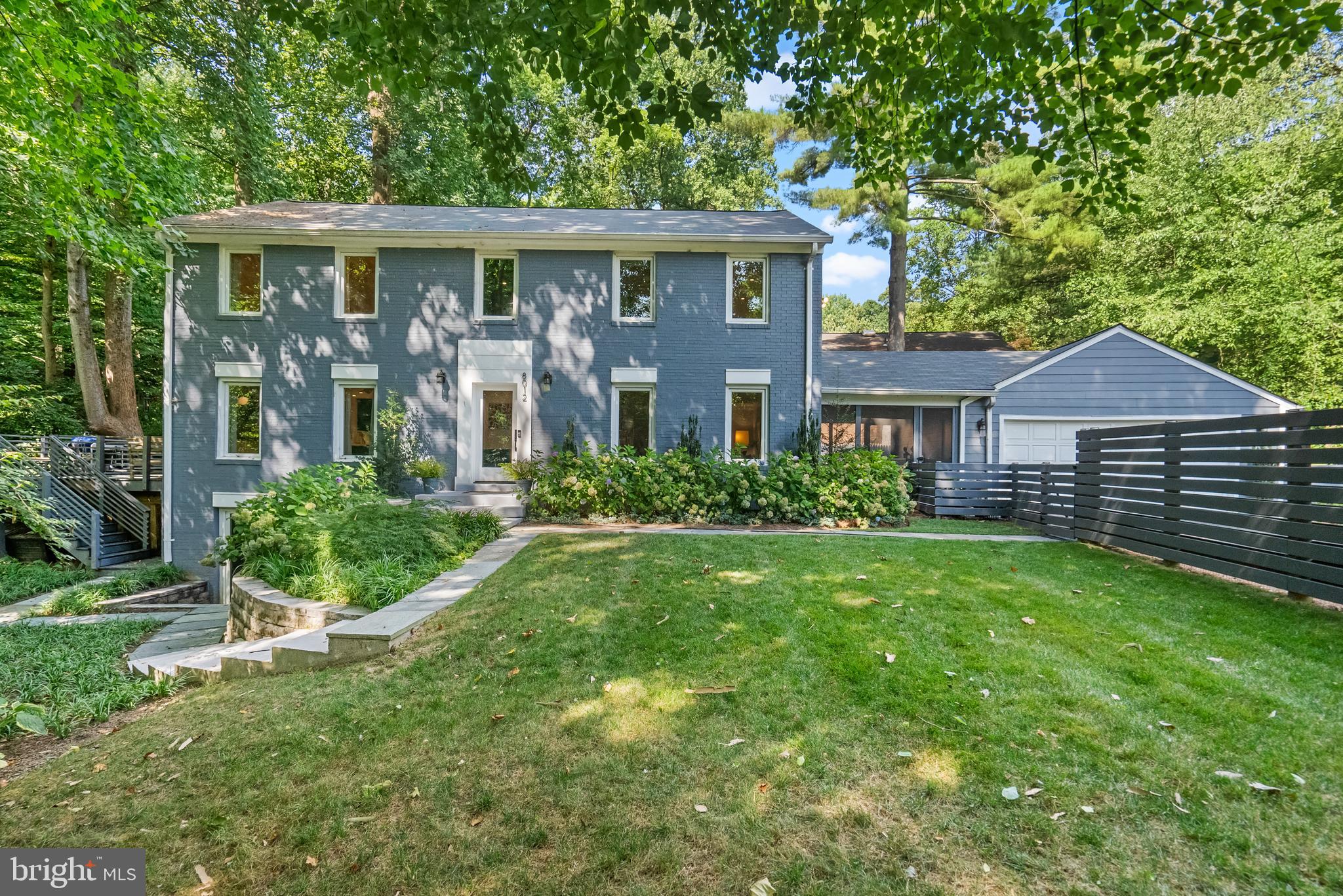 Tucked sideways off Lilly Stone at the back of the lot facing parkland & Cabin John Creek. Enter this garden oasis through a horizontal privacy fence & discover a fully renovated dream. 2018 gut-to-studs contemporary renovation features an open floorplan that make this home perfect for entertaining.
The focal point of the first floor is the chef's kitchen that features double-profile white Quartz countertops, custom navy cabinetry, a 5-person seated island with prep sink open to the family room. Professional-grade appliances include a dual fuel six=burner Wolf stove & hood, 24” built-in Leibherr refrigerator & freezer columns, Bosch dishwasher & additional convection wall oven make this a dream for any cook. A full light door leads to an expansive deck & patio tucked up against the park with ample space for BBQ’s & outdoor entertainment.  A luxury 1st floor full bath, large formal living & dining spaces highlighted by a wood-burning fireplace with slate feature wall that opens to large screened 3-season porch complete the first floor. 
Upstairs there is a large primary suite with custom designed walk-in closet & luxurious spa bath that features dual separate wall hung vanities, a wet area with oversized, dual headed shower & contemporary soaking tub. Three additional large bedrooms & second full bath complete the upper level. 
Downstairs you will find a large recreation room with separate exterior entrance, two more bedrooms with egress windows, & a full stylish bath offer any number of configurations - work from home spaces, room for live-in help, an in-law suite or a possible rental unit. A fully equipped laundry room with folding table, separate wash sink will make chores a breeze.  And an oversized utility & storage area complete with movable shelving & two full size additional refrigeration units that can be set to be used as either refrigerators or freezers.
Outside you have a large deck on one side, a screened 3-season porch that connects the 2-car garage to the house on the other, a dog run, raised garden beds, composting area & a fenced, meticulously landscaped garden & grassy area in front designed by a master gardener.