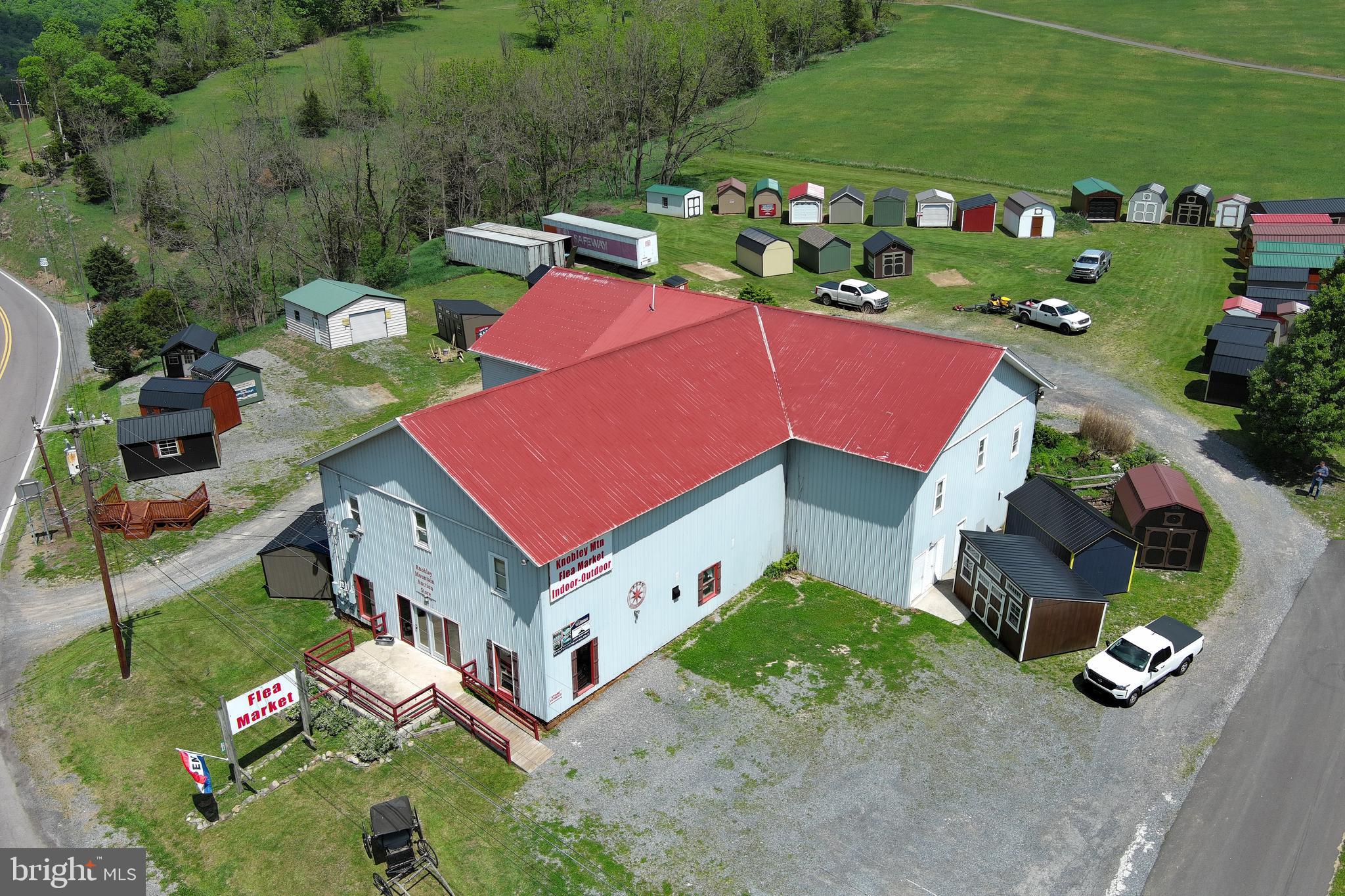 Huge building - Huge potential. Let your imagination run wild with more than 11,000 sq/ft of usable space offering endless possibilities for investment, business, or redevelopment. Originally constructed circa 1900 as a large barn, this unique structure has evolved into a diverse income-producing property with tremendous upside potential. The property currently includes a spacious 1,400 sq/ft apartment featuring 2 bedrooms, 2 baths, basement garage, laundry area, and additional storage space. The lower level of the barn is home to an active flea market with rented booth space, plus additional unused square footage ready for expansion or repurposing. Upstairs, you’ll find an office, kitchen, bathrooms, walk-up attic, and a large finished area currently sitting vacant and ready for new ideas. The current owner also utilizes the exterior lot space for a shed business and is open to leasing the grounds for future use. Positioned at a busy intersection with high traffic counts and exceptional visibility, this property offers rare flexibility with multiple avenues for cash flow generation all in one location. Strong rental history with a potential cap rate around 10%, plus a commercial appraisal completed just 2 years ago showing a value above the current asking price. A rare opportunity for the creative investor seeking scale, visibility, and income diversity.