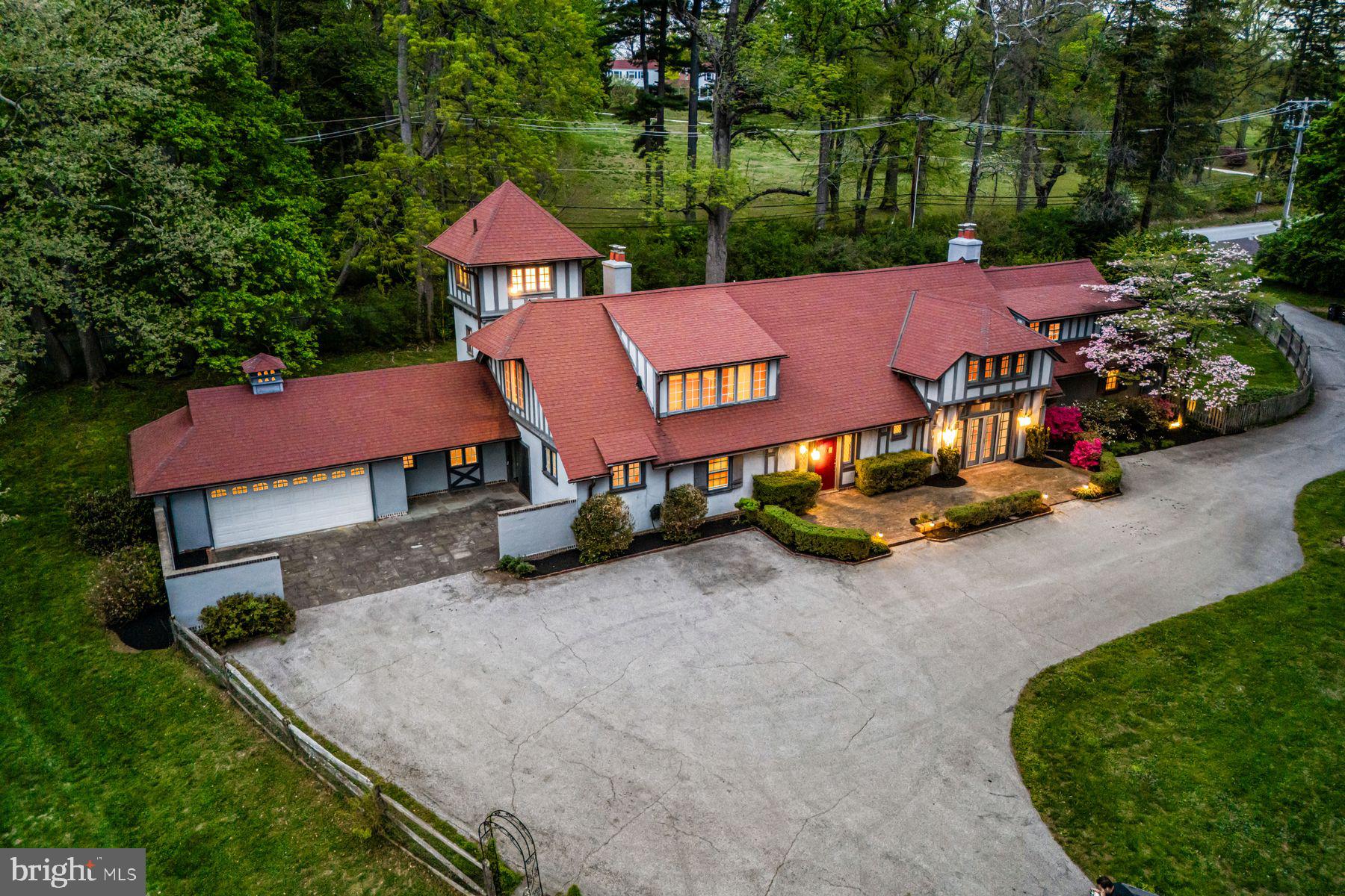 Charm abounds both inside and out at this one- of- a -kind 1901- built carriage house, set on a breathtaking 1.62-acre lot with private views at every turn and a tennis court in coveted Radnor Township. Beautifully restored, original architectural designs and materials have been seamlessly blended with modern renovations within an open, sun-filled floorplan with gracious room sizes and flexible living spaces. Endless features include tile or hardwood floors with freshly painted neutral decor throughout, recently renovated white kitchen with chef's appliances including a gas range, 4 renovated baths, including the primary bathroom which is artistically located in the stately cupola, a spacious entry foyer, expansive great room with bright windows, breakfast room and family room off of the kitchen, large library with fireplace and custom built-ins and a first floor suite area which could either serve as an in-law wing or large gym with full bathroom, laundry and access to the 2-car garage. Both the main foyer staircase and a secondary staircase off of the kitchen lead up to a well-designed second level showcasing a wonderful primary suite with high ceilings, a showstopper bathroom and plentiful closet space, a second bedroom with en-suite bathroom and a third and fourth bedroom/ pass through lounge with Jack and Jill bathroom. Once part of a grand Radnor estate, this rare gem still offers a wonderful retreat just minutes from Renowned Radnor and countless private schools, all forms of transportation including the Ardmore Amtrak station, a wide array of restaurants and shopping venues, clubs, diverse recreational facilities, Center City Philadelphia and Philadelphia International Airport. This treasure won't last long!