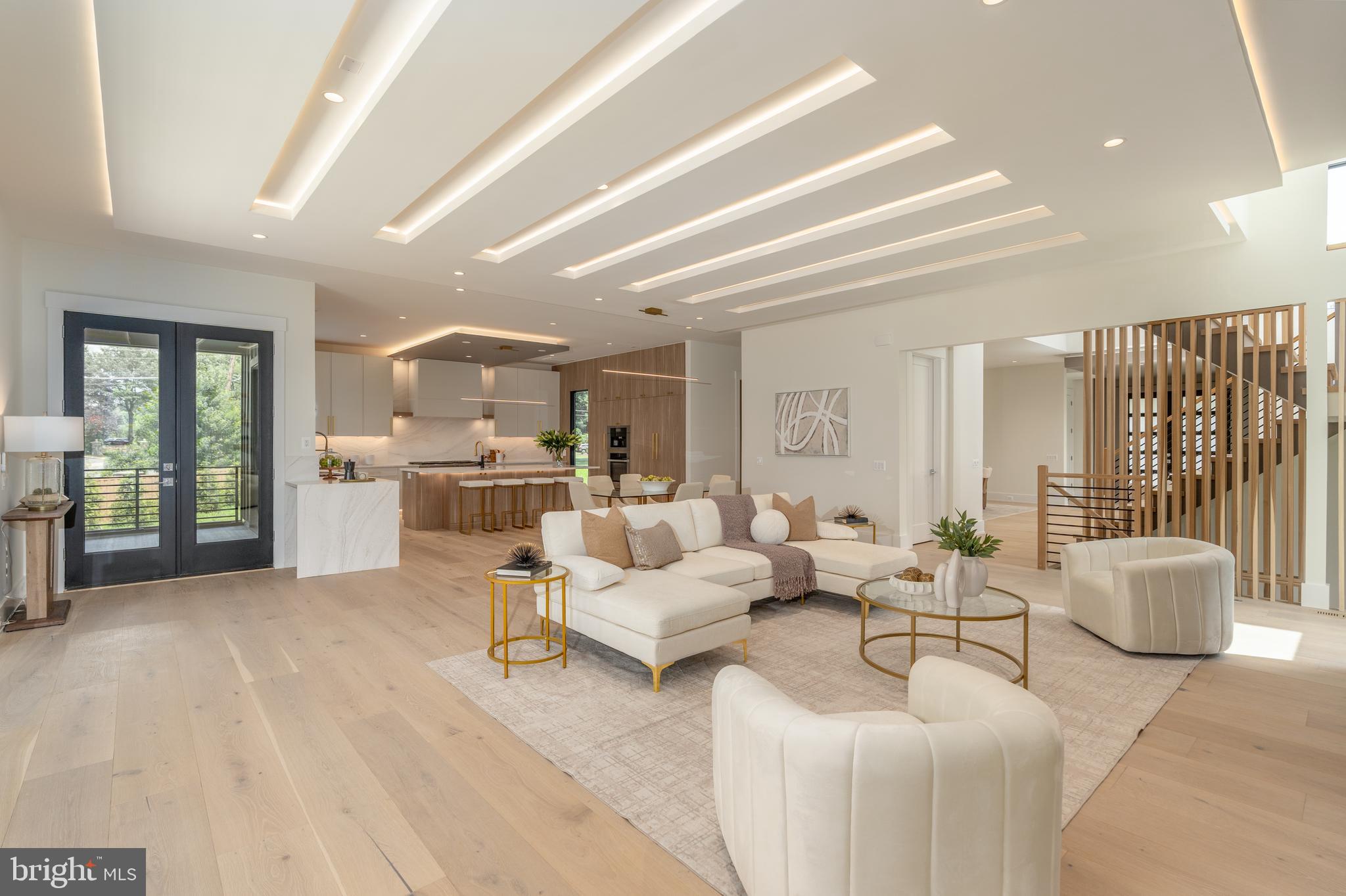 Experience elevated living in this luxury new construction architectural gem—where thoughtful design, luxury finishes, and a prime location just steps from Westwood Country Club come together seamlessly. Designed with entertaining in mind, this home offers the perfect setting for hosting everything from large celebrations to intimate gatherings with ease and elegance.
A dramatic two-story foyer welcomes you into over 7,450 square feet of artfully crafted living space featuring 7 bedrooms and 6.5 bathrooms. The open floor plan flows effortlessly through formal and informal living areas, highlighted by 10-foot ceilings, expansive picture windows, and warm wide-plank hardwood floors throughout the main level. The chef’s kitchen is a true showstopper—complete with a 9-foot center island. For easy everyday living there is a supplemental culinary food prep with a large sink, serving counter, built-in cabinetry and a second dishwasher. Miele appliances, a 60-inch side by side refrigerator, a built-in plumbed coffee station, and a separate butler’s pantry, all beautifully designed for everyday living and effortless entertaining.
The family room features a sleek ceiling design with integrated tape lighting, a linear gas fireplace with passive heat flow, and a wall of windows that open to a massive deck with a trellis-style ceiling and shades—creating a seamless indoor-outdoor experience for guests. There is also a screened porch which is accessible from the kitchen, family room and the deck.  Round out the main level is a secondary suite that can be used as an office or bedroom, adding to the versatility of the home's layout. Completing the main level is a spacious three-car tandem garage equipped with two EV charging outlets.
The open staircase, detailed with custom Poplar wood partitions, is a design centerpiece leading to the second level where you are greeted by a spacious informal living area. The primary suite is a luxurious retreat featuring its own heating and cooling system, two walk-in closets, a spa-inspired bath, and a private sitting room with fireplace—ideal for ideal mornings or unwinding at the end of the day.  Three additional spacious bedrooms each with its own bathroom and ample closet, and one with balcony for outdoor enjoyment.
The sprawling lower level features a stunning recreation area with a wet bar and a media room. Additionally, there are two flexible rooms that can serve as bedrooms or an exercise space, along with a full bath. French doors provide access to a covered patio, ensuring privacy and comfort for guests or multigenerational living.
Situated in a new, private six-home cul-de-sac with no HOA, across from the golf course —walkable to shops, Whole Foods, restaurants, and coffee spots, bike path, and minutes from Tysons Corner and Metro access. With standout design and a layout built for entertaining, this home delivers an unmatched lifestyle in one of Vienna’s most desirable locations.