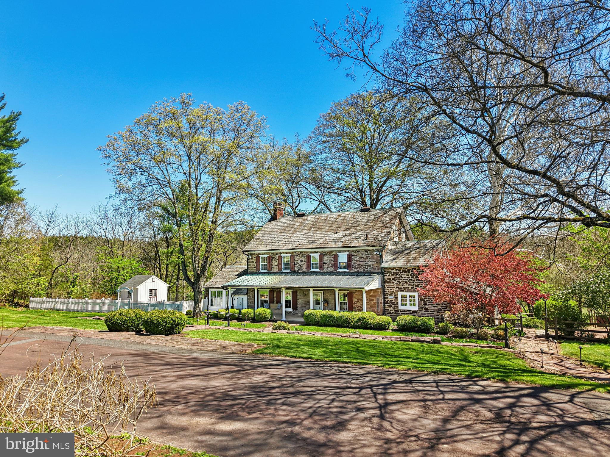This stunning 37.5 acre Bucks County gentleman’s farm is the perfect family compound, weekend getaway or full-time estate. The main house, guest house and converted barn present an unparalleled opportunity in the picturesque Pleasant Valley … whose name was suggested by location after the William Penn 1737 Walking Purchase. Set well off the road at the end of a tree-lined drive, the land unfolds in layers of open, tillable ground and verdant woodlands, framed by the pristine Cooks Creek, and traversed by bridges and trails. A seasonal chorus of birds, deer and wild turkey creates acreage best described as a living landscape.
     The main home on the estate is a circa 1850 classic stone farmhouse. Updated over the years by conscientious stewards, the home’s modern conveniences have been tastefully and carefully blended with many original features. One former owner, a play and screen writer, shared weekends at his farm with Alfred Hitchcock and other notables. Things of culture, grace and romance abound.
     A stone settler’s cottage, breakfast room, formal dining room, living room and expansive sunroom boast walls of windows that overlook a party-sized terrace with stone walls and a canopy of trees. Surrounded by a white picket fence, the inground pool is just steps away and beckons on a warm summer day. Outdoor entertaining can be casual or elegant, intimate or grand - all the amenities are here.
     Family and friends will enjoy the guest house, fully independent from the main house. Vaulted ceilings frame cozy rooms that include a sunroom, office, two bedrooms and two baths. For those who love the magic of gardening, the property also features a greenhouse, a flourishing orchard, and raised garden beds.
     Preserving the farm’s history, the landmark 1800s stone bank barn was renovated and expanded in 2016 and offers extraordinary opportunities and flexibility for offices, studio space, home schooling, parties and hobbies. A two-story great room with exposed beams, stone walls and barn ladder attest to the barn’s legacy. The reimagined and expanded spaces include a full kitchen, two powder rooms, full bath, conference room, reception room and five offices.
     For all your vehicles, toys, equipment, and hobbies, the property offers an oversized three-car garage, a fully outfitted equipment garage with cabinetry and a workstation, plus an additional detached two-car garage.
     Embrace a country home without sacrificing convenience. Located just 20 minutes from the Saucon Valley Country Club, the Pennsylvania Turnpike, I-78, and New Jersey. New York City is ninety minutes and Philadelphia one hour. Savor the splendor of nature’s elegance and serenity with an abundance of privacy. Enjoy the luxury of unhurried comfort, peace, privacy and tranquility, interrupted only by nature’s wonderful sights and sounds.    Additional 3 lots with 112 acres available.