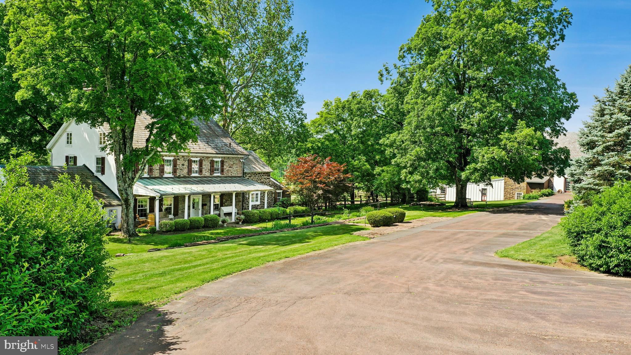 This stunning 37.5 acre Bucks County gentleman’s farm is the perfect family compound, weekend getaway or full-time estate. The main house, guest house and converted barn present an unparalleled opportunity in the picturesque Pleasant Valley … whose name was suggested by location after the William Penn 1737 Walking Purchase. Set well off the road at the end of a tree-lined drive, the land unfolds in layers of open, tillable ground and verdant woodlands, framed by the pristine Cooks Creek, and traversed by bridges and trails. A seasonal chorus of birds, deer and wild turkey creates acreage best described as a living landscape.
     The main home on the estate is a circa 1850 classic stone farmhouse. Updated over the years by conscientious stewards, the home’s modern conveniences have been tastefully and carefully blended with many original features. One former owner, a play and screen writer, shared weekends at his farm with Alfred Hitchcock and other notables. Things of culture, grace and romance abound.
     A stone settler’s cottage, breakfast room, formal dining room, living room and expansive sunroom boast walls of windows that overlook a party-sized terrace with stone walls and a canopy of trees. Surrounded by a white picket fence, the inground pool is just steps away and beckons on a warm summer day. Outdoor entertaining can be casual or elegant, intimate or grand - all the amenities are here.
     Family and friends will enjoy the guest house, fully independent from the main house. Vaulted ceilings frame cozy rooms that include a sunroom, office, two bedrooms and two baths. For those who love the magic of gardening, the property also features a greenhouse, a flourishing orchard, and raised garden beds.
     Preserving the farm’s history, the landmark 1800s stone bank barn was renovated and expanded in 2016 and offers extraordinary opportunities and flexibility for offices, studio space, home schooling, parties and hobbies. A two-story great room with exposed beams, stone walls and barn ladder attest to the barn’s legacy. The reimagined and expanded spaces include a full kitchen, two powder rooms, full bath, conference room, reception room and five offices.
     For all your vehicles, toys, equipment, and hobbies, the property offers an oversized three-car garage, a fully outfitted equipment garage with cabinetry and a workstation, plus an additional detached two-car garage.
     Embrace a country home without sacrificing convenience. Located just 20 minutes from the Saucon Valley Country Club, the Pennsylvania Turnpike, I-78, and New Jersey. New York City is ninety minutes and Philadelphia one hour. Savor the splendor of nature’s elegance and serenity with an abundance of privacy. Enjoy the luxury of unhurried comfort, peace, privacy and tranquility, interrupted only by nature’s wonderful sights and sounds.    Additional 3 lots with 112 acres available.