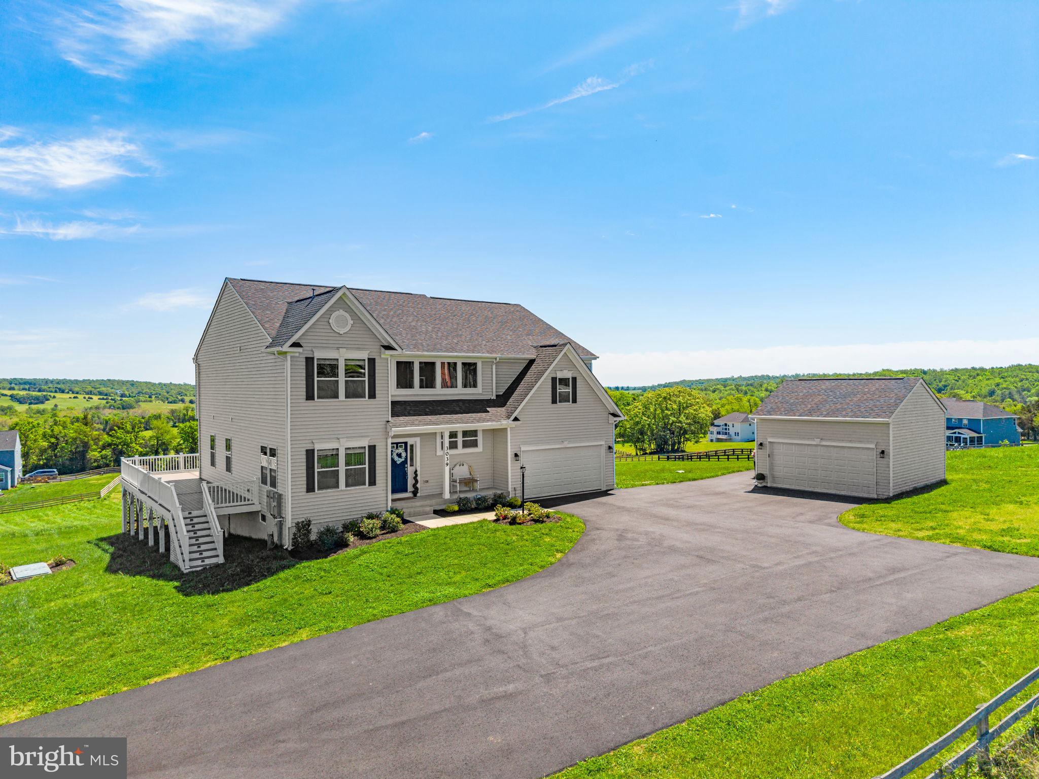 SELLER INCENTIVE : 2-1 buydown now offered. Enjoy lower monthly payments w/ an interest rate 2% lower in year 1 & 1% lower in year 2. An opportunity to own a beautifully appointed 6-bedroom, 5.5-bath home on 6.82 scenic acres in Warrenton. Only a year old, this home captures breathtaking 360-degree mountain & pastoral views from every window  while offering the convenience of being just minutes from historic Old Town Warrenton.
Some of the best views in Fauquier county, must see to believe. Enjoy  elegant everyday living & effortless entertaining, the home features an open floor plan, airy foyer, & striking hardwood staircase leading to upper-level breezeway. Main level includes a highly desirable soundproofed primary suite, flexible office or sitting room, & a cozy gas fireplace w/fireproof insulation. Expansive windows and sliding glass doors fill the kitchen and sunroom w/natural light while framing sweeping views in every direction.
The kitchen is beautifully finished w/quartz countertops, an oversized island, 5-burner gas range, abundant cabinetry, & generous seating for gathering. Throughout the home, 32 Levolor cordless wood blinds add comfort & style, including vertical blinds on the sliding glass doors. Eleven motorized tilt blinds on the main level, operated by two remote controls, provide added convenience.
Just beyond the main living area, the 540-square-foot wraparound TimberTech composite deck extends the living space outdoors, creating a remarkable setting for entertaining, relaxing, and enjoying rolling summer storms or star-filled skies. The main level also offers a spacious pantry, practical mudroom, & fully insulated attached garage w/double-ceiling insulation for added sound reduction & temperature control.
Upstairs, four generously sized bedrooms include a second expansive primary suite w/a full-length walk-through closet featuring reinforced flooring designed to support a gun safe. The luxurious bath offers a soaking tub, walk-in shower, dual vanities, & private water closet. A nearby secondary bedroom enjoys its own private full bath & walk-in closet, while two additional bedrooms share a spacious full bath w/ double vanity. Laundry is conveniently located on the upper level.
The lower level adds versatility w/a large additional bedroom, full bath, abundant storage, & plumbing for a future wet bar. Surround sound prewired for five ceiling speakers &a subwoofer.
Additional features include a July 2025 whole-home Generac generator w/first-year maintenance &a 10-yr. warranty, attached 2-car garage w/ extra R-15 insulation & EV wiring, & a detached oversized 2-car garage that is fully insulated & fully electric. The attached garage also includes plumbing, electric, & venting for a stackable washer/dryer, offering the option for an additional laundry area. Paved asphalt driveway extensions provide easy turnarounds and ample parking.
The home is thoughtfully equipped for modern connectivity, w/five Cat 6 data ports behind five TV locations, an 8-port gigabit network switch, & conduit run to the attic prior to drywall. Starlink  supports multiple TVs  streaming simultaneously, and high-speed remote work. The home is  also completely future ready for solar power.
Additional upgrades include extra  pre-drywall insulation in all interior walls, closets, basement ceiling attached garage walls (including a second ceiling)  & upper-level bonus room alcoves. Further enhancements include dual whole-house water filters, high-output well pump, Trinity security system prewiring, Cat cable networking, Leaf Filter whole-house gutter guards w/warranty. “Elite” 2-10 Home Buyers wall-to-wall warranty extended to 4/12/2027, transferable, truly wall to wall, includes rekeying & upcoming annual AC tuneup. Additional 2 yr & 10 yr warranties remain in place as well. Seller had many additional privately paid inspections throughout entire building process ensuring excellent craftsmanship. No HOA.