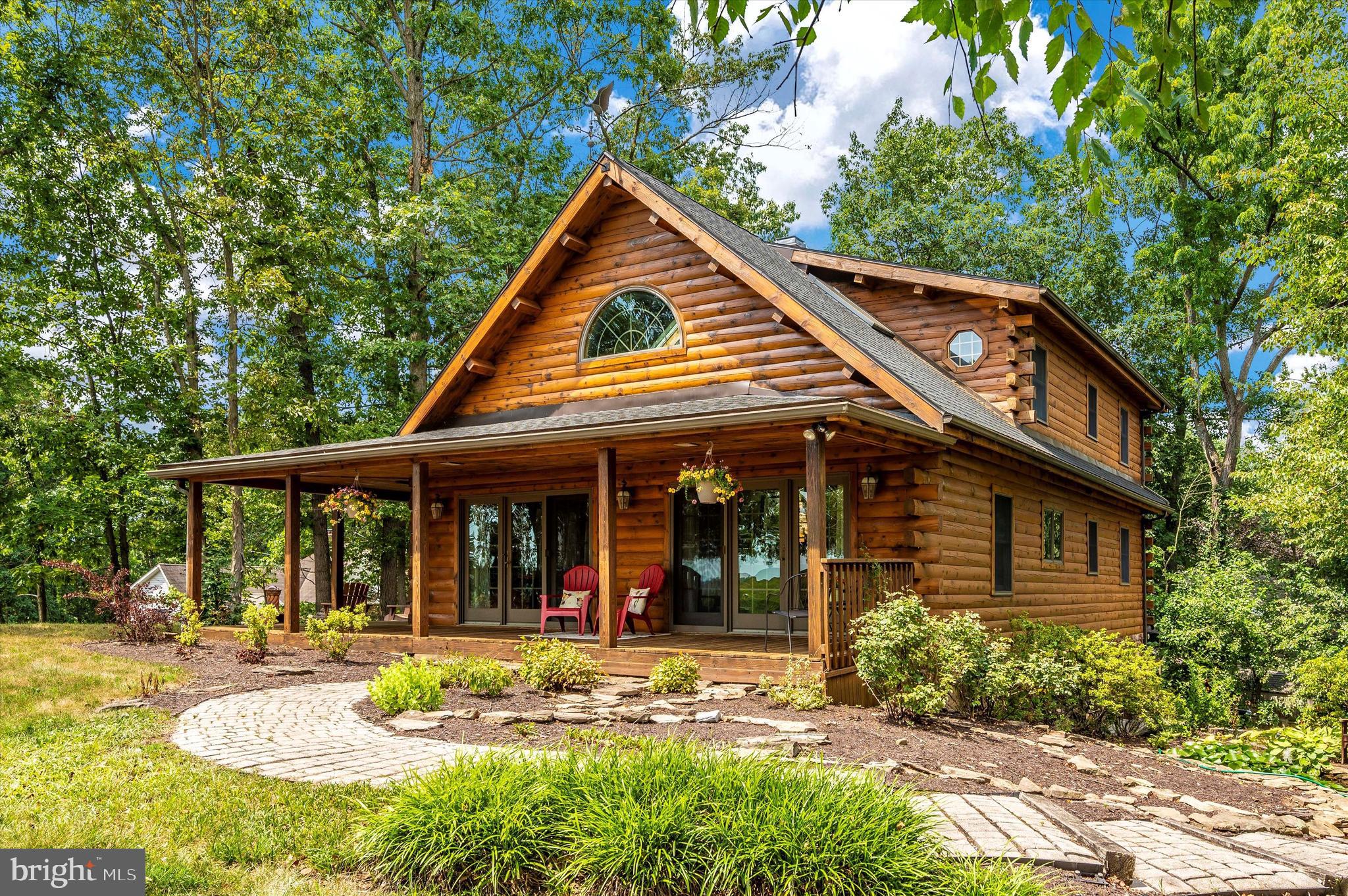 Welcome to this beautiful log home located in a picture perfect setting! You do not want to miss out on all that this Lake Meade property has to offer. Situated on a corner wooded lot with a great view of the lake, this three bedroom, three full bath home features an open floor plan with cathedral ceilings, skylights, beautiful floor to ceiling stone fireplace, first floor owner’s suite, loft, sunroom, fully finished lower level, and lovely landscaping. Enjoy your morning coffee on the large wrap around covered porch. Tranquility awaits, don’t miss out on your chance to make this house your next home!