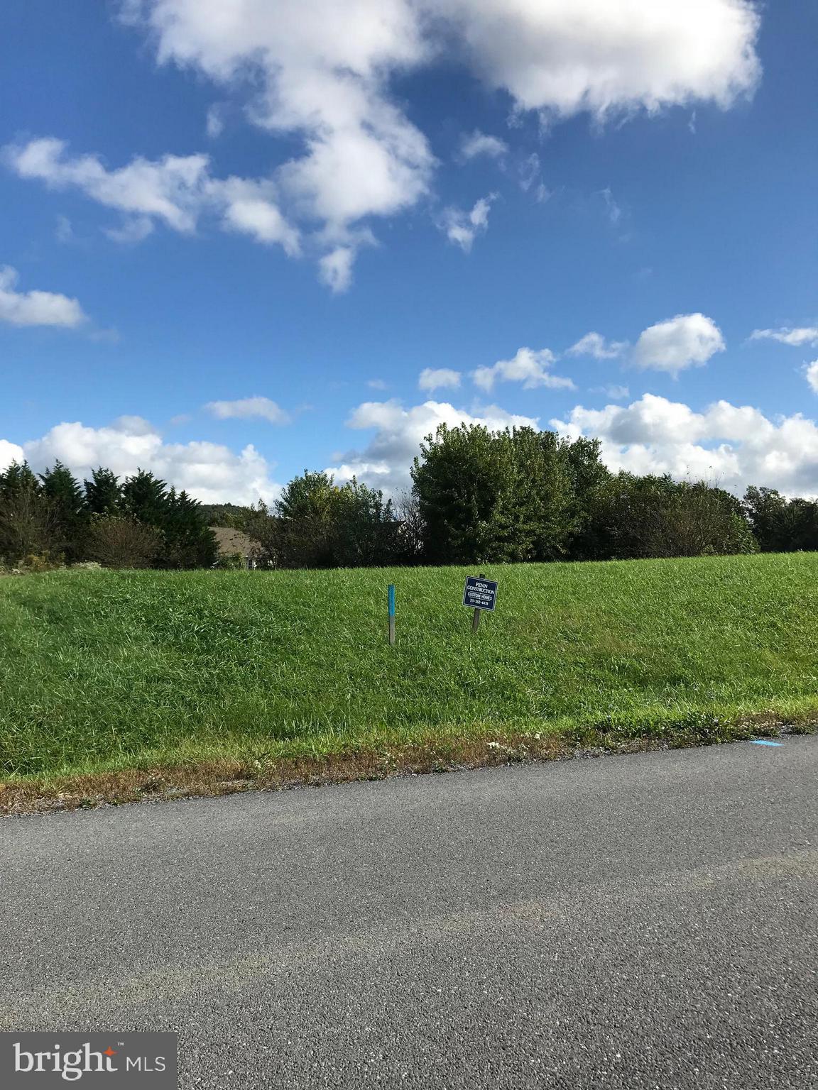 Lot 49 is a .57 acre lot situated on a bend with 232 arch feet across the front! This lot will support a large single level home very nicely. Neighborhood prices averaging 300/400k.  Natural gas available.