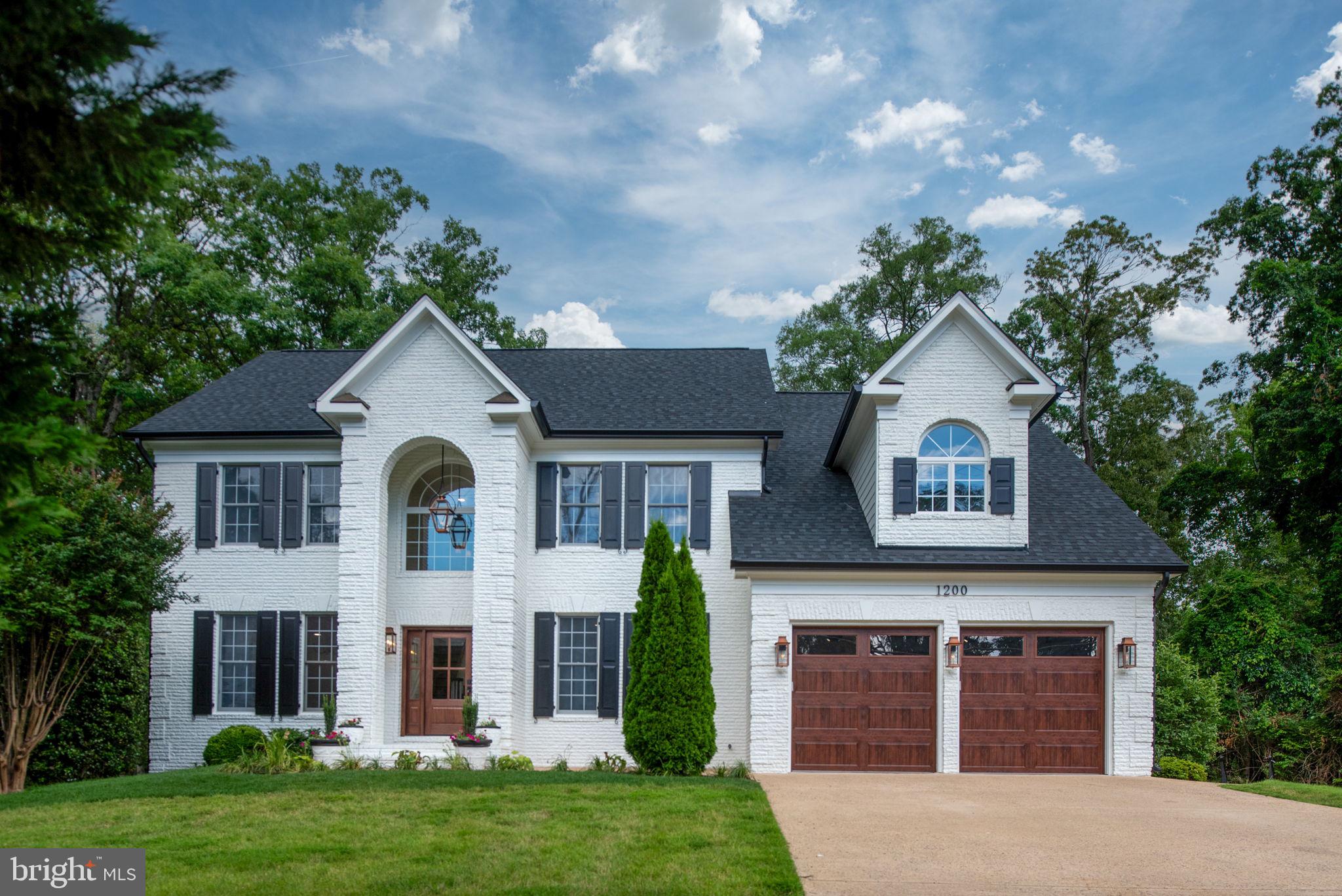 Welcome to 1200 Alexandria Ave, a beautifully reimagined brick colonial in the heart of Fort Hunt’s desirable Tauxemont neighborhood. This timeless home was fully remodeled in 2025 by the Zelaya Homes team, blending classic architecture with high-end finishes and thoughtful design throughout. Situated on a flat 0.4-acre corner lot, the property offers a large side yard—ideal for play, entertaining, or potential additions like a pool or sport court. The main level features a traditional yet functional floor plan with 9’ ceilings, a formal dining room perfect for hosting, a family room, a sunny living room with a wood-burning fireplace (complete with gas line for future insert), a main-level study that can double as a 7th bedroom, and a fully finished four-season sunroom with built-in wall AC and access to the new Trex deck and patio. The gourmet kitchen is the heart of the home and has been completely redone with semi-custom soft-close cabinetry, premium quartz countertops with ogee edging, under-cabinet lighting, a commercial-grade 48” Thor gas range with a pot filler and custom range hood, a 42” Sub-Zero fridge with in-door water and ice dispenser, drawer microwave, dishwasher, dual-zone beverage and wine fridge, a deep 36” apron-front sink with a prep sink on the island, and a walk-in pantry with built-ins and a unique pantry access door to the garage for easy grocery unloading. Upstairs, the primary suite is a showstopper, featuring soaring cathedral ceilings with custom wood beams, expanded closets, and a spa-inspired bathroom. The luxurious bath includes marble floor and wall tile, an oversized soaking tub (72”x36”), heated floors, a dual-sink custom vanity with extra storage, built-in LED-lit mirrors, and a large walk-in shower with dual showerheads, a hand sprayer, and bench seating. The upstairs also includes a new laundry room and completely renovated secondary bathrooms, each featuring designer tile and Delta fixtures. The fully finished basement now includes two additional bedrooms with egress windows, a large recreation area, and a custom wet bar with mini fridge, microwave, and sink. New plush carpet, recessed LED lighting, and stylish finishes make it a welcoming extension of the home’s living space. The $500K+ renovation includes new architectural asphalt shingles, new gutters, new custom wood painted functional shutters, fresh landscaping, and upgraded exterior lighting with authentic gas-burning lanterns. Inside, new hardwood floors have been installed and refinished on both the main and upper levels. Every room features upgraded lighting, dimmable recessed LEDs, and designer fixtures. Extensive custom millwork includes crown molding, trim, and ceiling accents throughout. The garage includes new insulated doors, an epoxy-coated floor, and a built-in dog wash. Smart home touches include Ecobee thermostats. The upstairs HVAC units are new as of June 20, 2025. The lower level HVAC systems and water heater were professionally serviced and remain negotiable for replacement, if requested by the buyer. 1200 Alexandria Ave is ideally located in the walkable Tauxemont community—just steps from parks, playgrounds, sport courts, coffee shops, restaurants, grocery stores, hardware and pharmacy essentials, and the beloved Mount Vernon Park Association with three swimming pools, tennis courts, a private pond, and more. Enjoy easy access to the scenic George Washington Parkway, Old Town Alexandria, the Pentagon, Fort Belvoir, Amazon HQ2, and Downtown D.C. Located in the highly rated Waynewood Elementary School district, this one-of-a-kind property offers a rare opportunity for luxury living in an established, close-knit neighborhood.