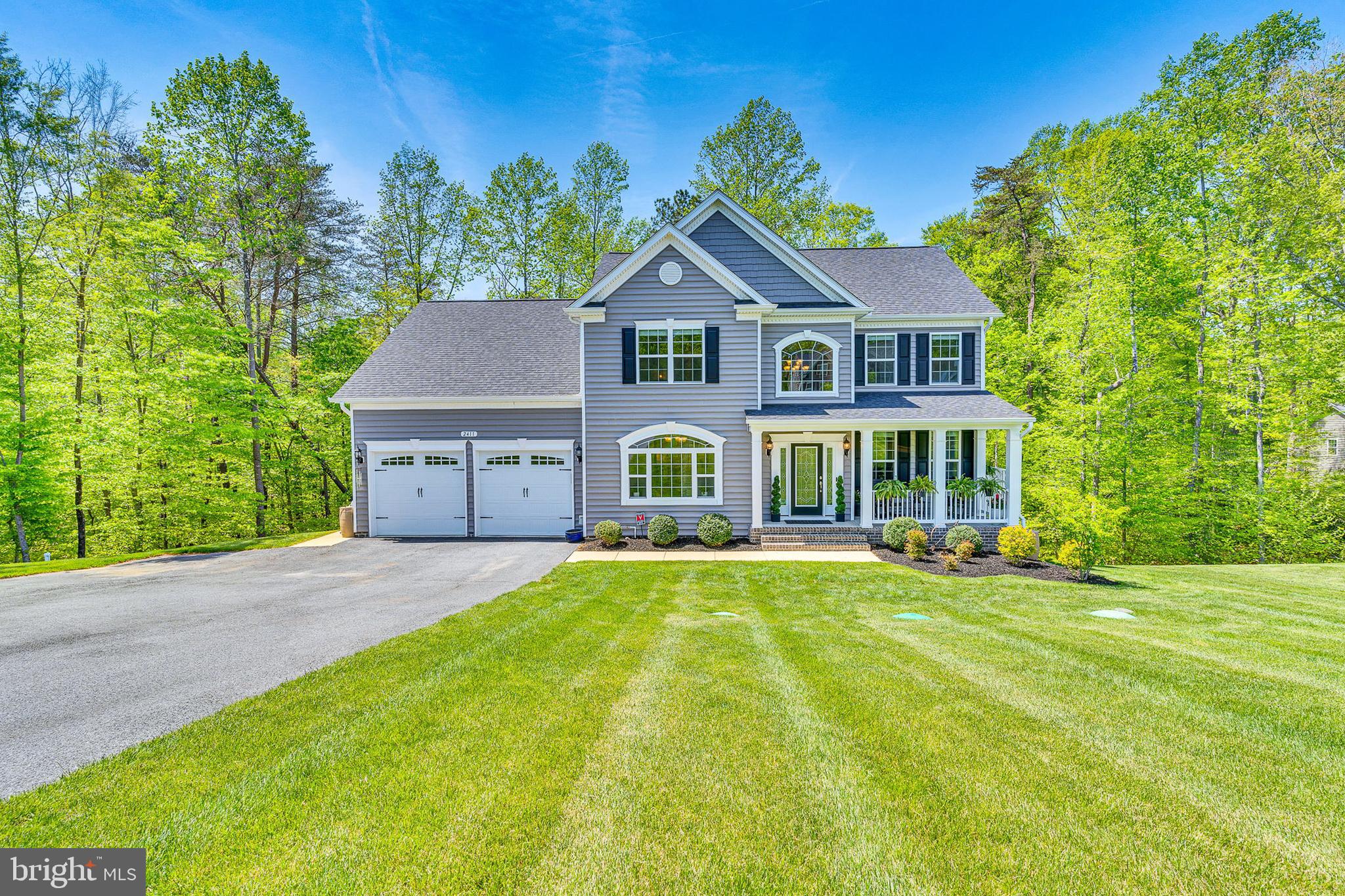 Welcome to 2411 Comptrollers Ct, a like-new, 4-year-old home in the highly desirable Oakland Hall community of Prince Frederick, MD, that is steps away from the Community Pool & Clubhouse.  Impeccably maintained, this spacious home offers three finished levels and is loaded with builder upgrades, including extensive crown moldings, gleaming hardwood floors throughout the main level, and a stunning two-story entry with a beautiful staircase. The open-concept kitchen and family room. Features a cozy gas fireplace. The kitchen has a large island, two pantries, and seamless access to a maintenance-free wrap-around deck overlooking a serene, wooded backdrop. With 5 generously sized bedrooms and 3.5 baths, the home is ideal for families or anyone seeking space and comfort. The luxurious primary suite includes custom closets, a tray ceiling, and a spa-like bath with a pedestal soaking tub, oversized shower, and dual vanities. The finished lower level offers a large recreation room, a bedroom with a full bath, and an expansive storage/utility area. Additional features include a whole-house water softener and chlorination system, plus an underground lawn irrigation system to keep your yard lush. Just steps away, the community pool and clubhouse are hubs for summer fun, while year-round events like the Fourth of July parade, Halloween festivities, Turkey Bowl, and cornhole tournaments foster a true sense of community. Conveniently located near Joint Base Andrews, PAX River, DC, and Annapolis—and in one of Maryland’s top-rated school districts—this is more than a house; it’s the lifestyle you’ve been dreaming of. Make 2411 Comptrollers Ct your new home and start creating lasting memories. EV and RV charging available.