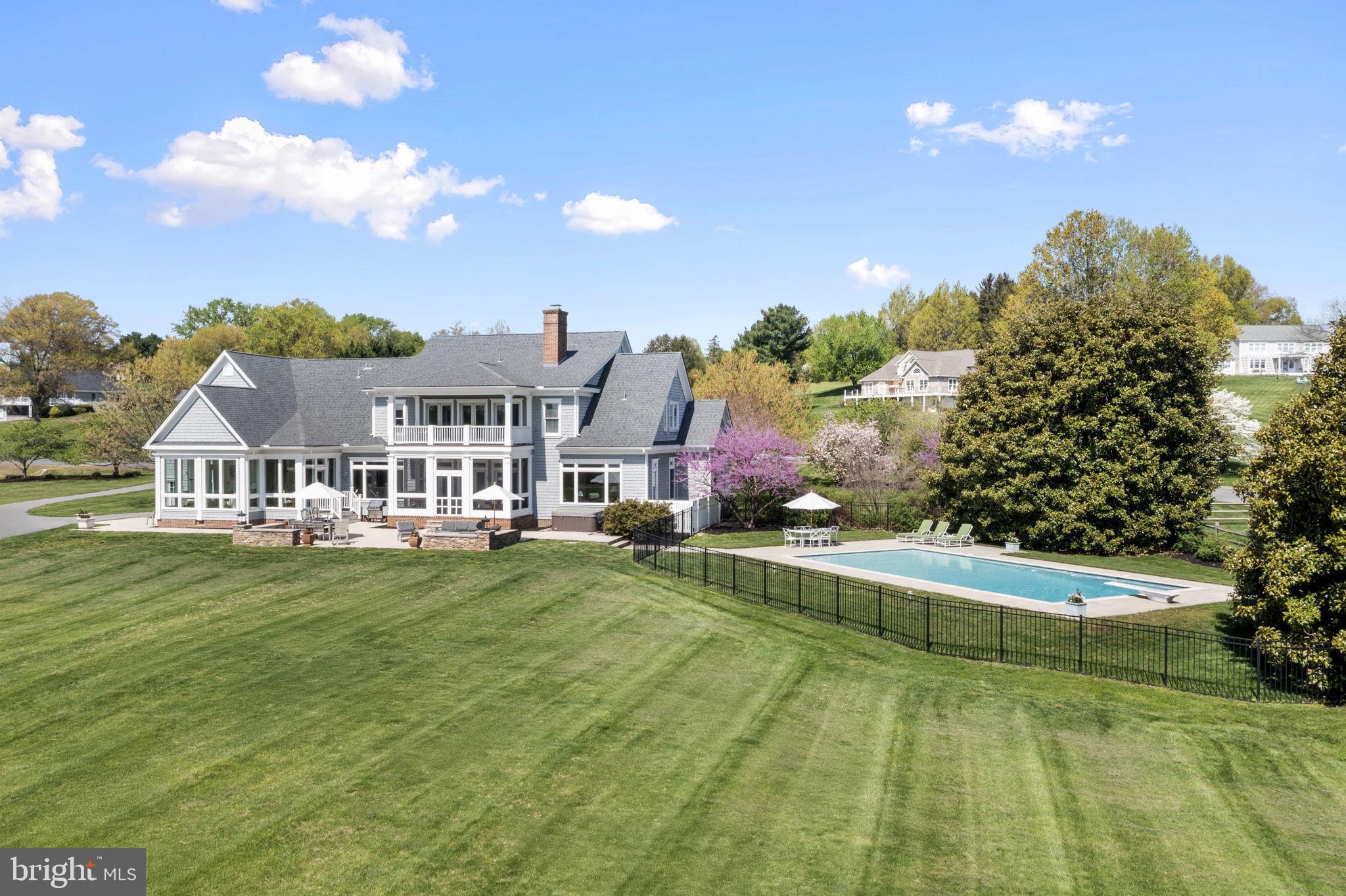 Waterfront living takes center stage the moment you arrive at this stunning two story Southern Living cape cod. The home, built in 2002, is nestled on 3.17 gently rolling acres. The residence captures sweeping views of the majestic Elk River and Inter coastal waterway.

This coastal living home has a natural cedar shake exterior, Brazilian hardwood porches, brick to grade construction, all of which set the tone for the timeless quality that continues inside. The main level unfolds in an open, yet traditional flow, highlighted by 10ft ceilings, extensive crown moldings, a coffered ceiling, Rumford wood burning fireplace, custom cabinetry and Brazilian cherry hardwood floors. Walls of windows frame the ever changing water views and flood the home with natural light. A chef’s kitchen, with gas cooktop, anchors the entertaining spaces. The kitchen, sun room and screen porch, transition seamlessly onto an expansive limestone patio, overlooking the pool and river.

Upstairs the primary suite feels like a private retreat with its own river view balcony, dual walk in closets, spa sized bath; four addition bedrooms and two full baths, provide ample space for family and guests. All interior and exterior furnishings may convey.

Mechanical confidence continues with a six year young dual zone HVAC system with propane back up. A new roof and recently plastered pool add to this well cared for home. A certified septic and termite inspection was completed in 2024.

A three car garage, generous parking pad and long drive make hosting effortless.

The property is a nature lovers dream, with 299 ft of river front, relax on your private sandy beach, kayak, boat, crab or watch the majestic ships pass through the C&D Canal. Bring your boat, and dock in your personal slip that conveys with the property, located on the community pier. Riparian rights, of the waterfront, permits you to hunt waterfowl and apply for your own private dock. Located in the quaint neighborhood of St John’s Manor, residents enjoy modest HOA dues that cover community green space, a private boat ramp, guest pier, and pond access. The bylaws even allow for horses. If you have been waiting for a show stopping waterfront property that blends craftsmanship, comfort and unforgettable views, your search ends here.