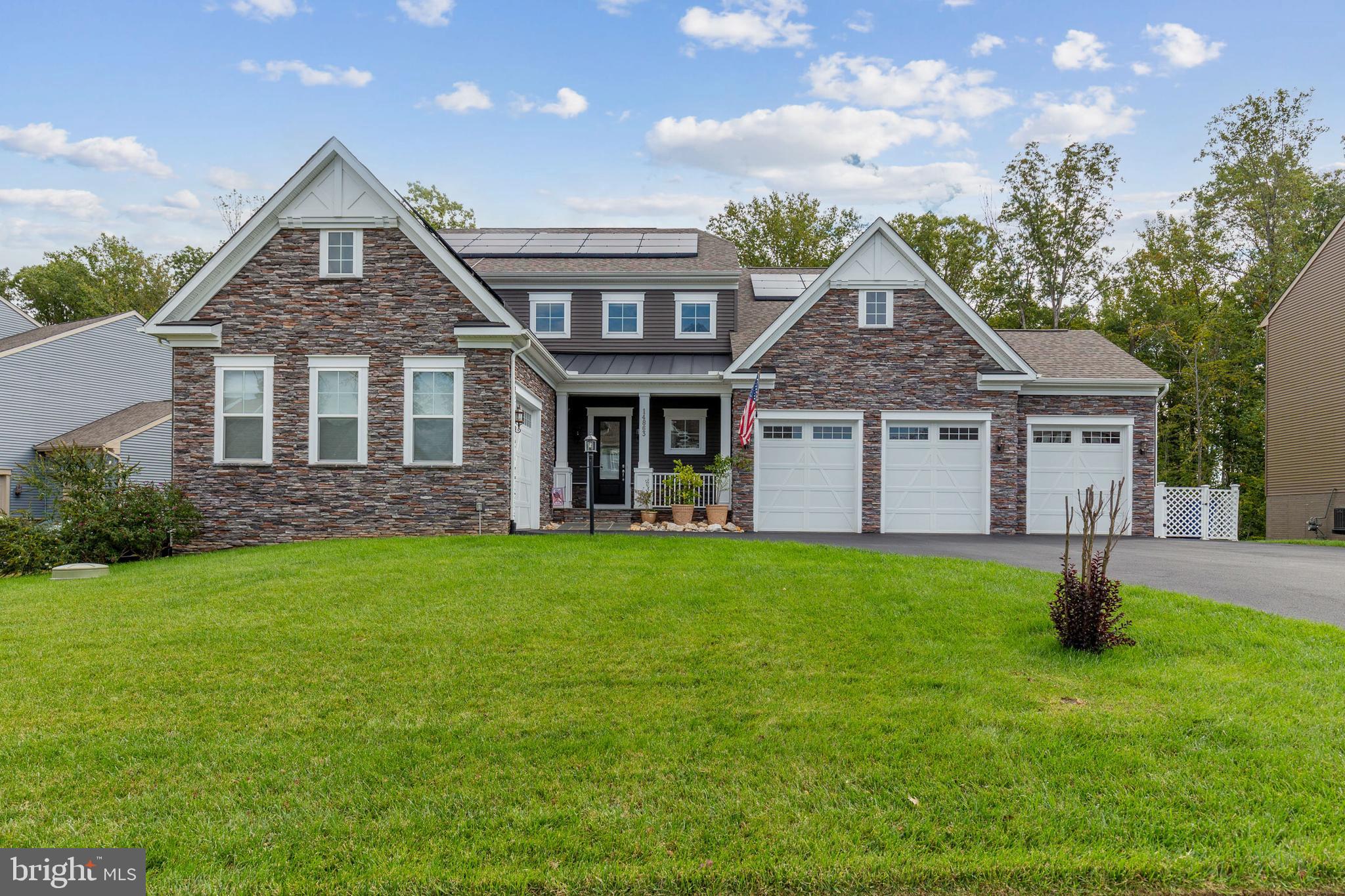 Stunning Estate Style Colonial Home built in 2020 showcases a perfect blend of modern elegance and timeless craftsmanship. This magnificent home features 5 Bedrooms, 4.5 Baths and a 4 Car Garage. This home has solar panels and a Tesla wall that allows the home to go 95% off grid! (this is a $150,000 upgrade) As you enter this amazing home you notice the extra high ceilings. The Foyer (and entire main and upper levels) has LVP Floors. (Over $100,000 in highest upgraded LVP floors and tile) The wide-open floor plan beckons you into the main Family Room with Coffered ceilings and a Gas fireplace that is massive and composed of stacked stone from floor to ceiling.  The automatic blinds on the entire main level can be set to open at sunrise and close at sunset! There are three commercial grade ceiling fans ($15,000 value) on the main level. The main level and entire home has a complete surround sound system! The gourmet kitchen is a chef's dream, and boasts granite counters and granite waterfall on the island. There is a large Farm sink, Stainless steel appliances, gas cooktop, microwave/oven combo. The gorgeous white cabinets have a special treatment that resists fingerprints and dirt.  There is a reverse osmosis system in the Kitchen. The office has a pocket door and is located off the Kitchen.  There are beautiful custom-built shelves in the Home Office. Adjacent to the kitchen, There is a large Formal Dining Room that sets the stage for memorable meals. The nice size Sunroom adds additional entertaining space! There is a private ensuite (Mother-in-law) on the main level with its own Family room, Bedroom, Bathroom and Kitchen. It has dual heat/air and its own entrance and garage. Upstairs you will find three massive size bedrooms. There is a Family Room on the bedroom level with 12 Foot Ceilings and a TV and console that convey. There is a custom surround system that also conveys.  The Primary Bedroom is massive with a large sitting area.  The custom primary closet is large and has tons of drawers and hanging space for all your needs. The Primary bath has wood look tile floors, dual shower heads, a shower seat, and recessed lighting and dual vanities. Bedrooms 2 and 3 are also large and can accommodate Queen size beds. Both secondary bedrooms have walk-in custom closets. The additional full bath has tile floors and is large in size to accommodate the secondary bedrooms. The Washer and Dryer are located on this bedroom level.  The Washer and dryer room has custom cabinets and space to hang your items.  The front load washer and dryer convey. The Basement boasts a $60,000 Movie Room with a TV that conveys. This room has upgraded carpet. There are three commercial grade ceiling fans here as well. The kitchenette in the basement has a Wet Bar with a dishwasher, DuraForm cabinets and bar seating for 6 people. Plenty of cabinet space for all your party entertaining! There is a full bedroom in the basement along with a full Bath. The basement gym has workout equipment that conveys. All of the gym equipment is top of the line. The French door walks out to the stamped concrete patio in the backyard with a firepit.  The storage shed has 20-amp service. There is a garden on the side of the home with herbs and an electric dog fence as well as  a whole yard inground sprinkler system. Ceiling fans are all commercial grade. There are 2 water Heaters, steam humidifier, and 2 heating systems. An upgraded complete home fresh air system pulls fresh air in every 30 minutes. In the four-car garage there is an electric car hookup, TESLA Power wall system and the floors have all been treated. Home is wired for CAT6 (Fastest internet). There are a total of 3 refrigerators and 3 dishwashers that convey. Don't miss this amazing well cared for home!