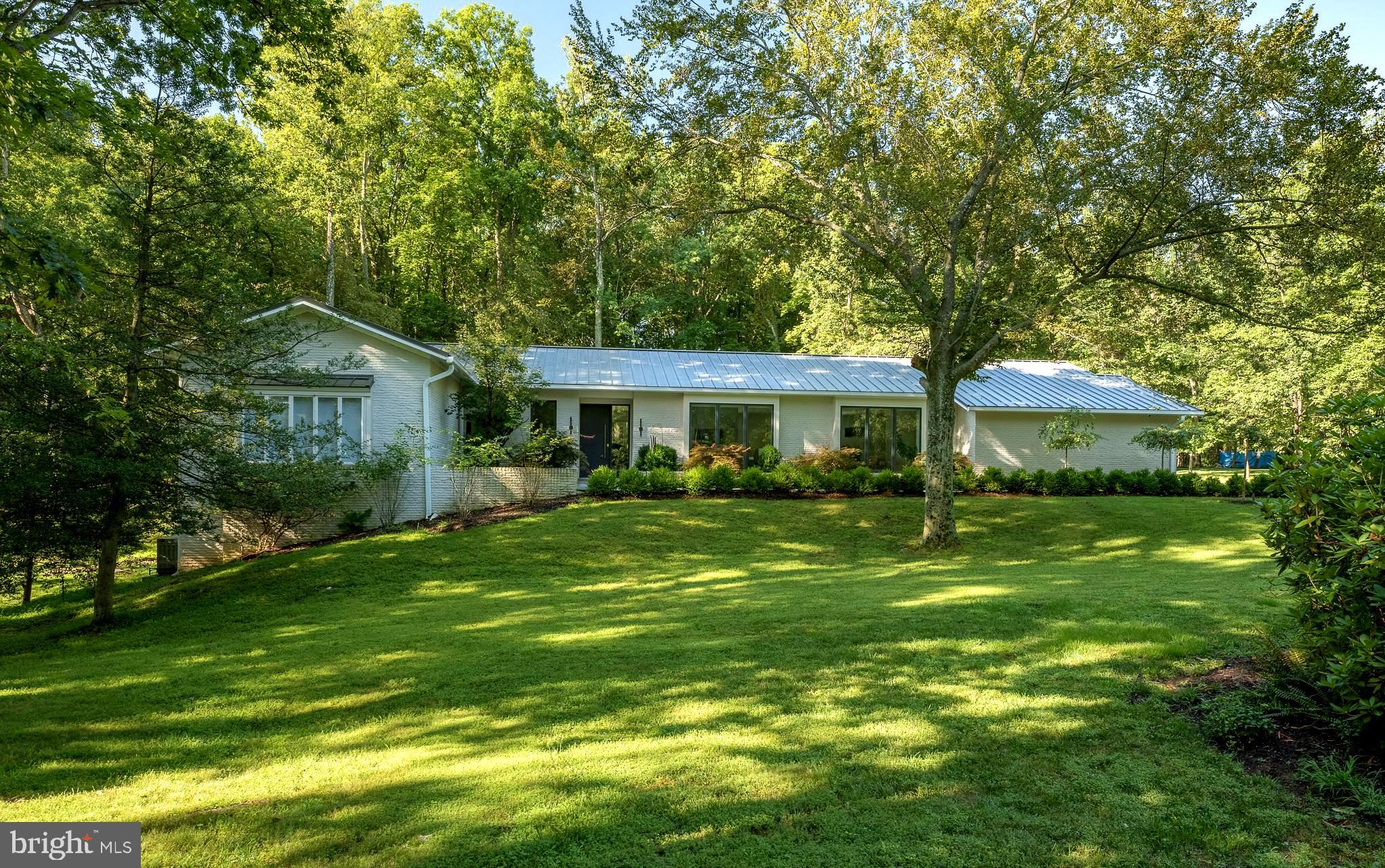 Perfect for buyers seeking understated luxury and effortless living, this home offers a rare blend of clean-lined modern design, sun-filled open spaces, and cutting-edge smart technology with serene natural surroundings—without the upkeep of oversized, high-maintenance estates. Ideal for those who value comfort, quality, and privacy over extravagance. Fully rebuilt and completed in 2020 with over $1.1M in top-of-the-line finishes, systems and custom features, this stunning 7BR (or 6 BR + office), 4.5BA contemporary home is on 2 private acres lot in one of Potomac’s most prestigious neighborhoods--CAMOTOP. Features include all-new electrical, plumbing, dual HVAC (2 systems, 3- Zoned), backup generator, and smart home tech. The chef’s kitchen boasts Sub-Zero, Wolf, and Asko appliances, custom cabinetry, and quartz counters. TWO primary suites—one on each level—make this ideal for multigenerational living. Spa-like baths, heated tiled floors in primary bathroom, Marvin windows, soaring ceilings, custom steel front door, biofuel fireplace, Lutron Caseta lighting, Nest thermostats, Simplisafe security, whole-house ethernet and mesh WiFi, motorized Somfy shades, the list goes on. The designer finishes throughout. Walk-out lower level with GE Café kitchen, game room, and an office(or 7th BR) with private entrance. Abundant storage. Professionally landscaped yard with large stone patio, Japanese garden, smart home integrated pathway and landscape lighting system designed by Outdoor Illuminations, stormwater management system and existing tennis court (pre-wired—ready for renewal). Just minutes from Potomac Village, top schools, country clubs and major commuter routes. NO HOA. This is a must-see modern masterpiece. Offer deadline: 2 PM on Sunday 8/10/2025