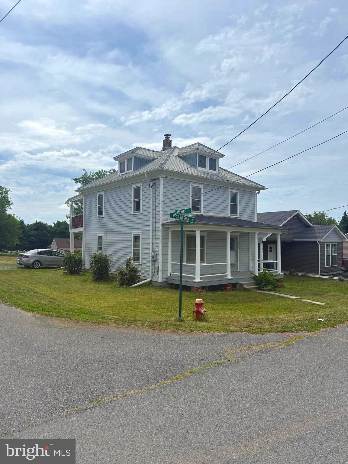 Great in-town location on the southern end of West Virginia Avenue! Situated on a desirable corner lot, this home features a spacious rear yard, off-street driveway parking, and a small outbuilding for additional storage. Relax on the inviting front porch or enjoy the double-tiered rear porch overlooking the backyard.
Inside, the main level offers a traditional layout with a living room, dining room, and kitchen. The second floor features three bedrooms and one full bath. A cellar-style basement provides additional storage space. Conveniently located near shopping, dining, schools, and other local amenities, this property offers plenty of potential for an owner-occupant or investor.